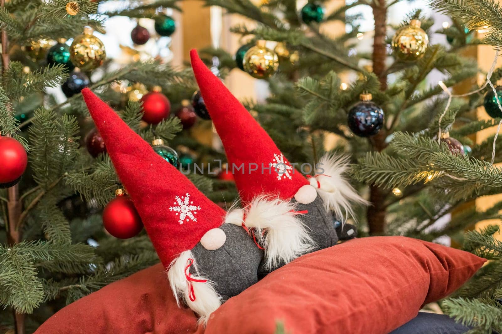 Old Scandinavian Dwarf Wearing Gray Clothes and Red Hat. Christmas Gnome on White Background with Free Space for Text.