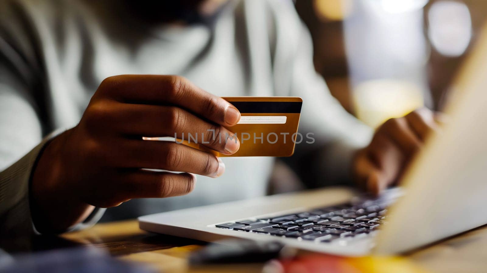 A person interacts with a laptop while holding a credit card, engaged in online shopping in a warm, inviting environment during the evening hours - Generative AI