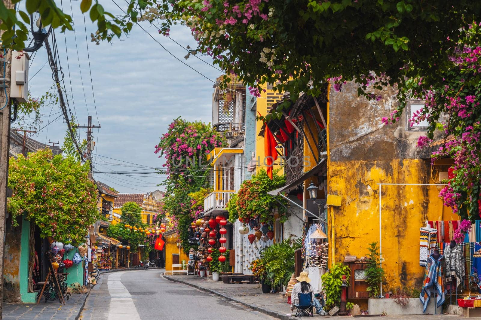 streets with traditional ancient yellow houses and buildings in the old town in Hoi An city in Vietnam in summer at day