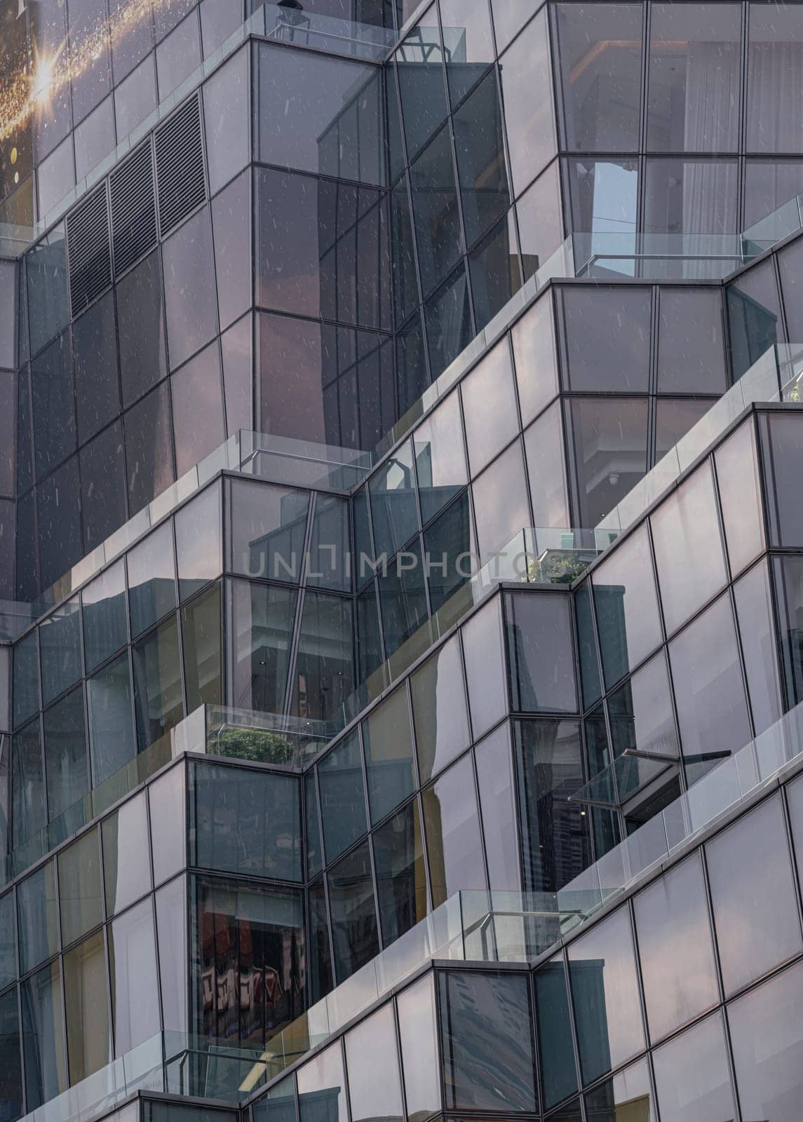 Bangkok, Thailand - 28 Sep, 2024 - Architecture exterior of Modern building with many glass wall reflecting with the sky background at afternoon. Space for text, Selective focus.