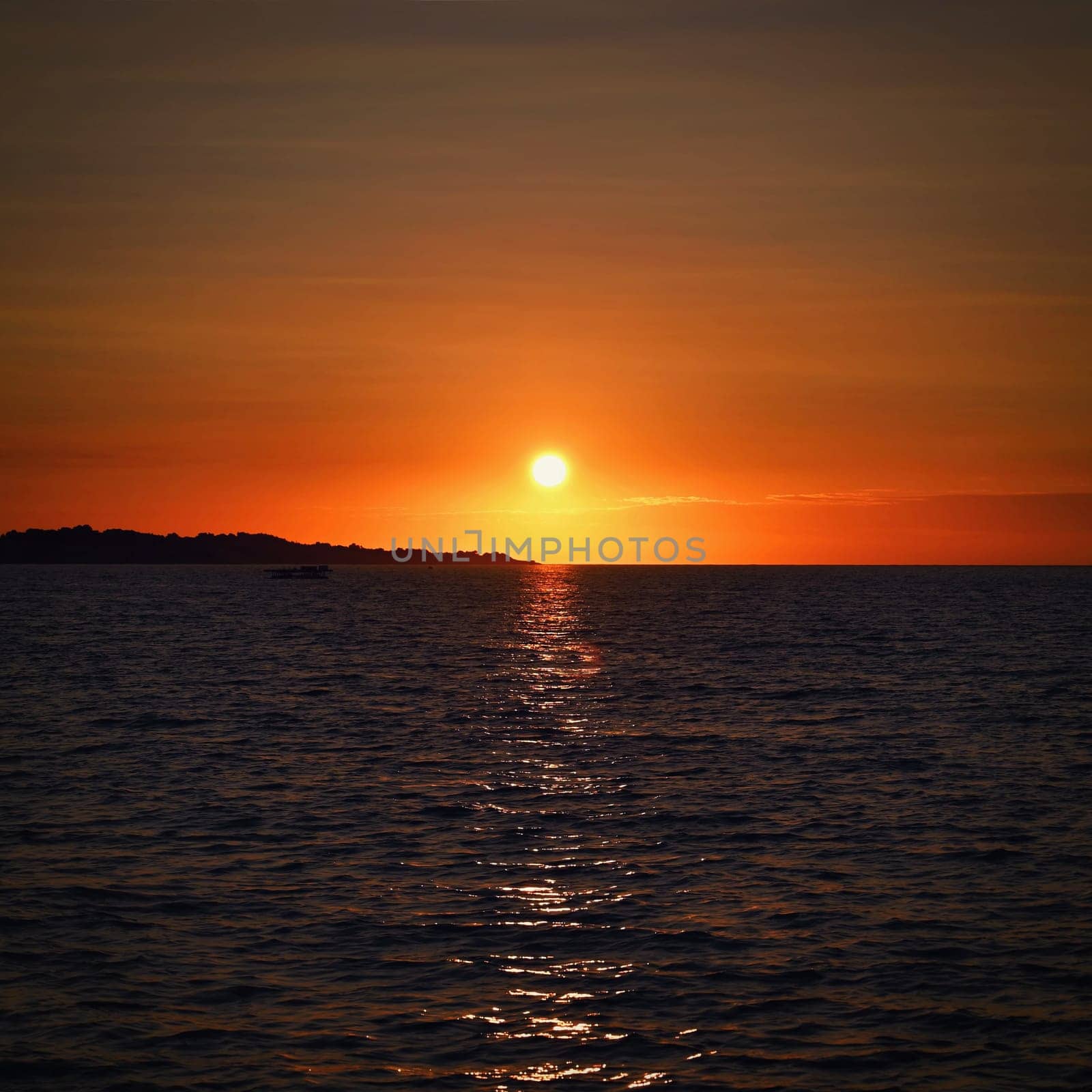 Beautiful colourful sunset on the beach with the sea and waves. A concept for travel, holidays and summer holidays by the sea. Greece - Corfu island - Agios Georgios