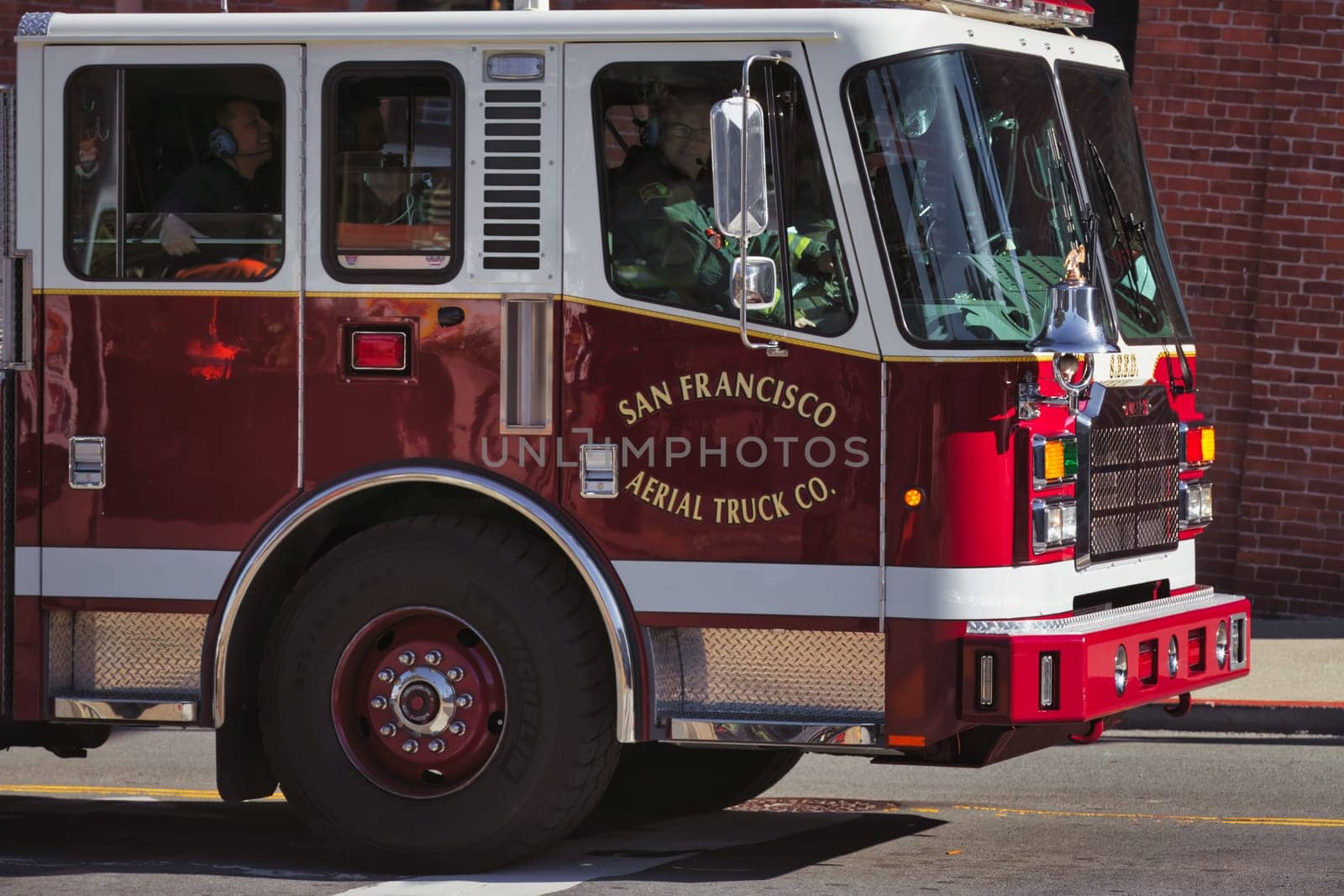 Capture the essence of bravery and community service with this striking image of a San Francisco Fire Department truck. Seen in its iconic red color, the vehicle is well-equipped and ready to respond to emergencies. Whether it's for a news article, public service campaign, or educational material, this photo conveys urgency, preparedness, and the valor of our first responders