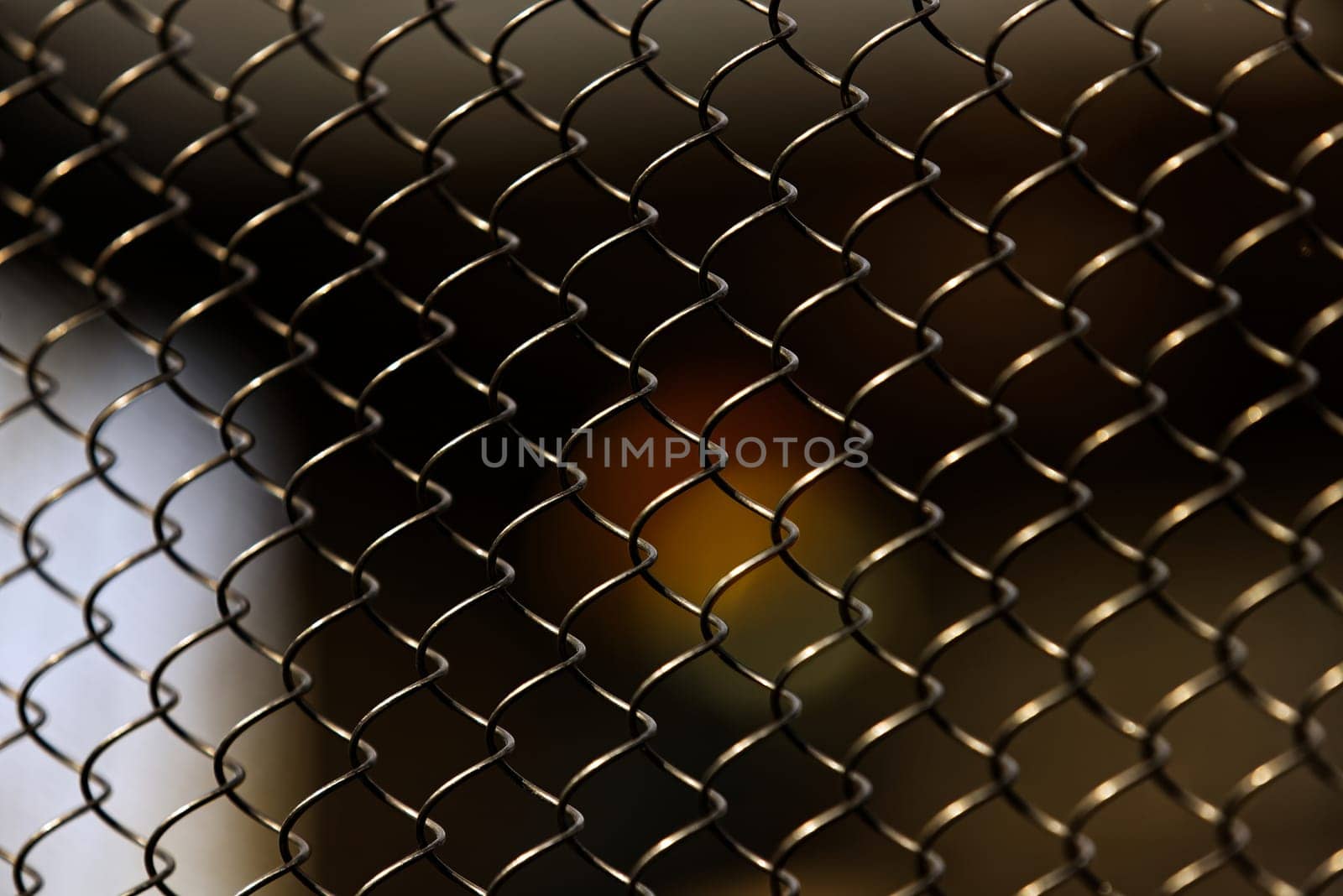 Captivating in its simplicity, this photograph features an array of chain link fences that form a compelling geometric pattern. The composition of the fences creates a harmonious blend of light and shadow, transforming a common, utilitarian object into a work of art. This photo captures the unexpected beauty found in everyday life.