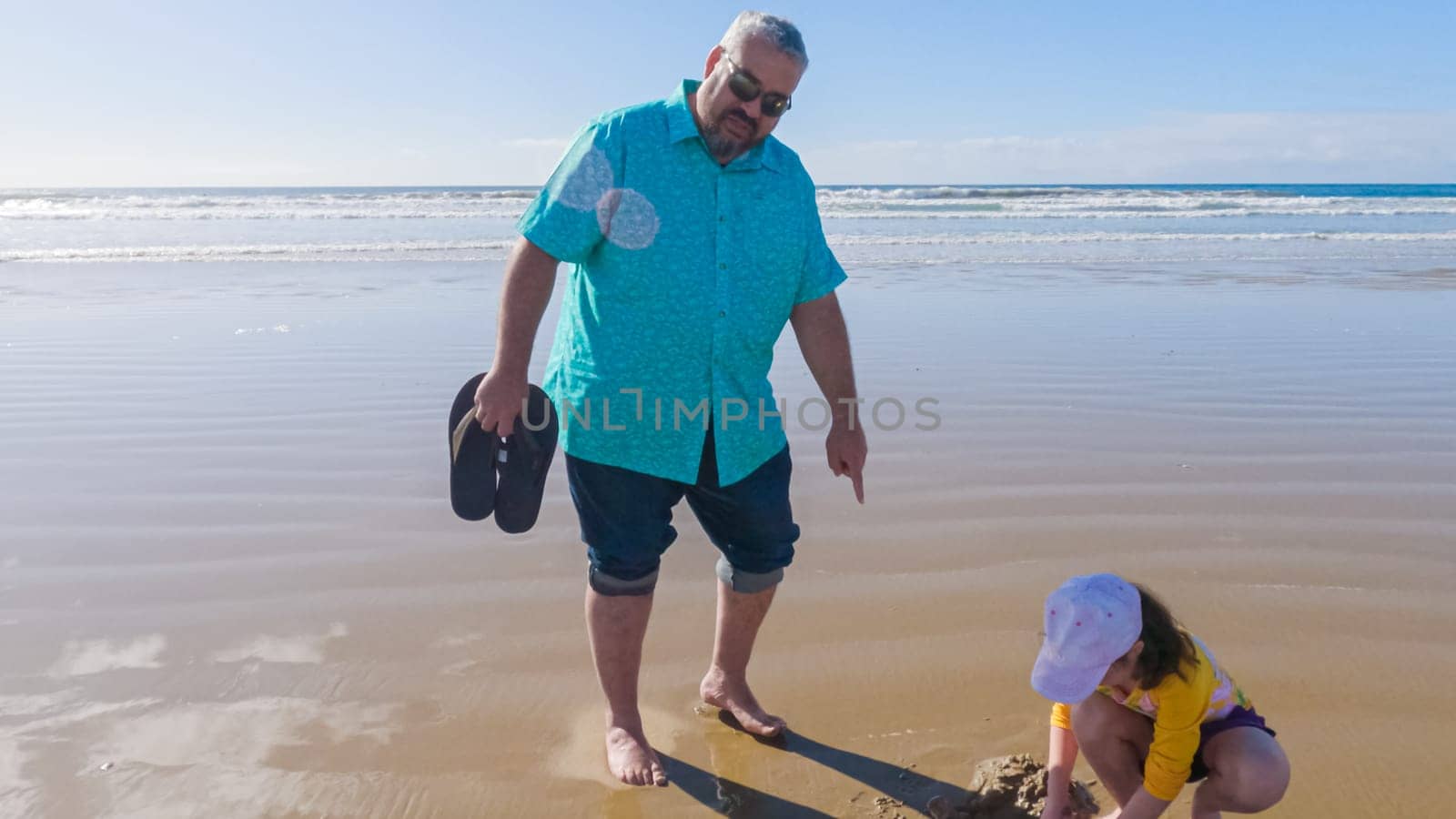 Little girl winter clamming at Pismo Beach by arinahabich