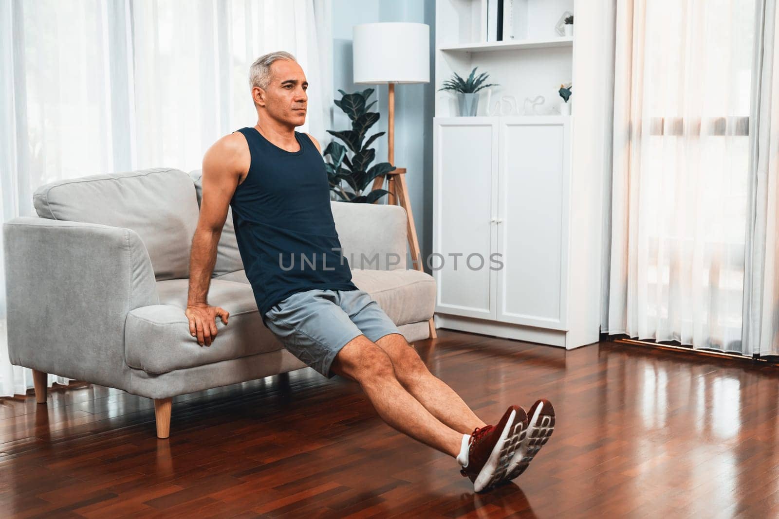 Athletic and active senior man using furniture for pushup. Clout by biancoblue