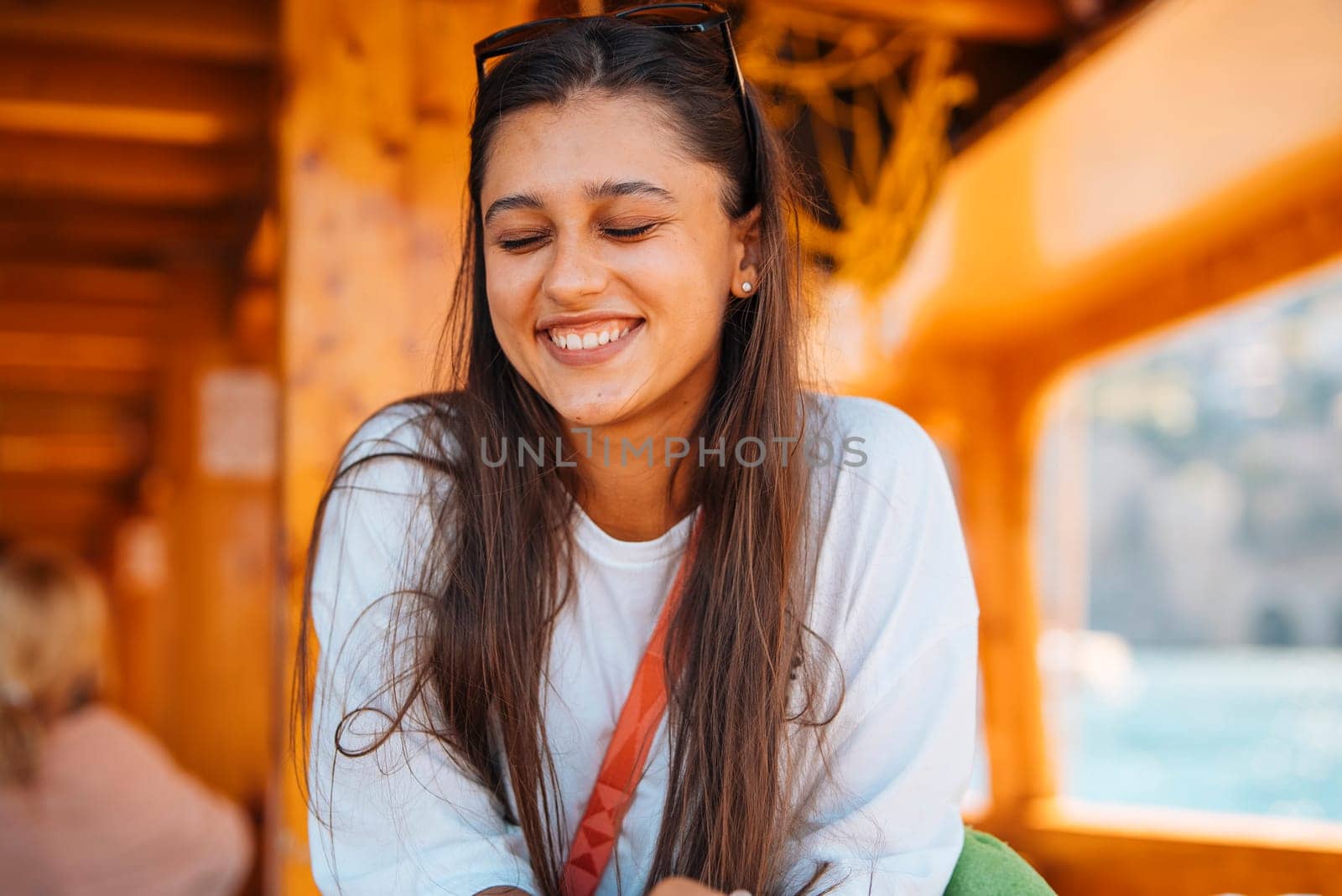 A joyful woman beams with happiness on a delightful boat ride, surrounded by the stunning beauty of nature
