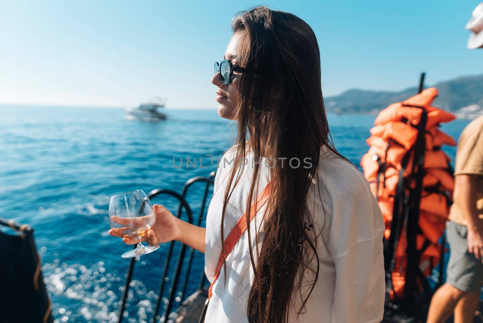 Enjoying a peaceful moment on a luxury yacht, taking in ocean views while sipping a drink embodies true relaxation