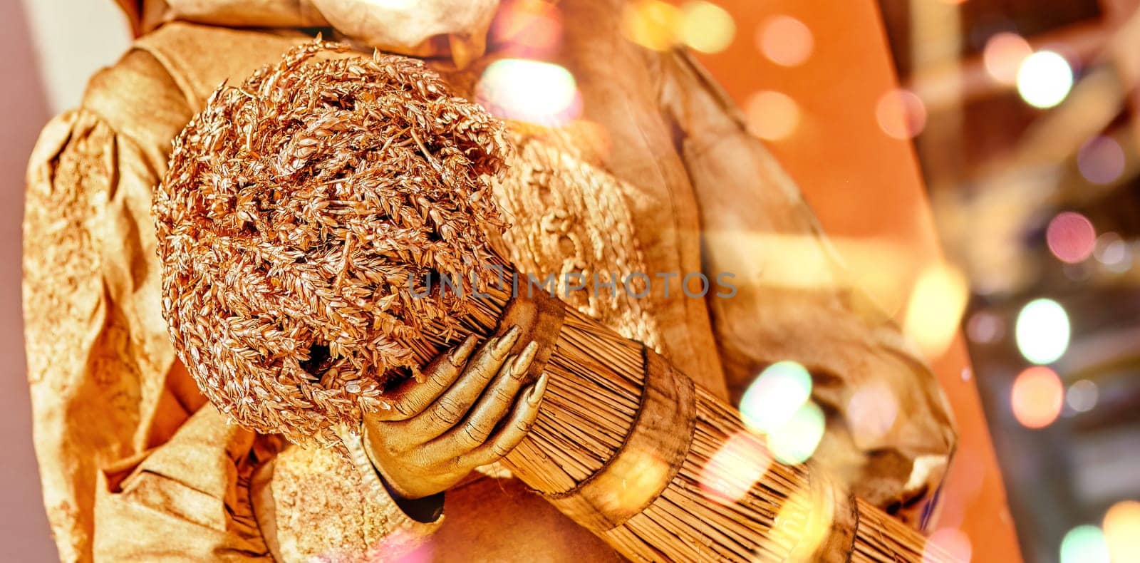 A dazzling golden figure holds a beautifully crafted bouquet in a vibrant market, surrounded by the joyful energy of a daytime celebration filled with colorful lights.