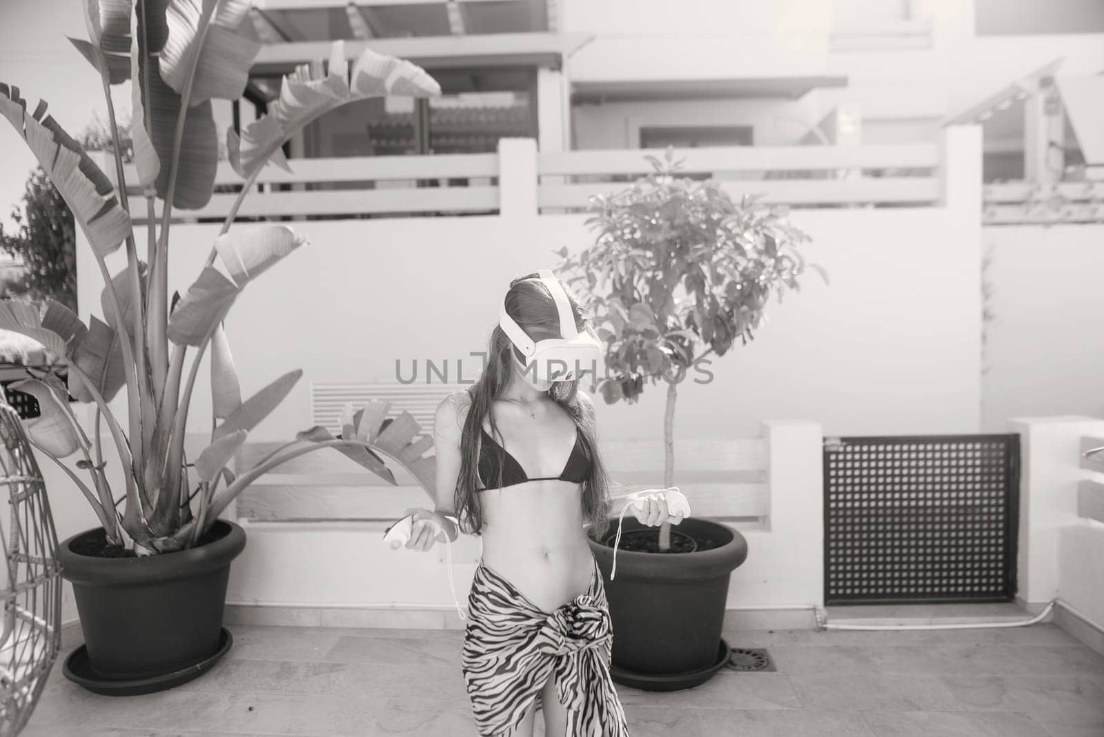 A skilled dancer poses elegantly in a lush, enchanting backdrop, creating a stunning visual in black and white
