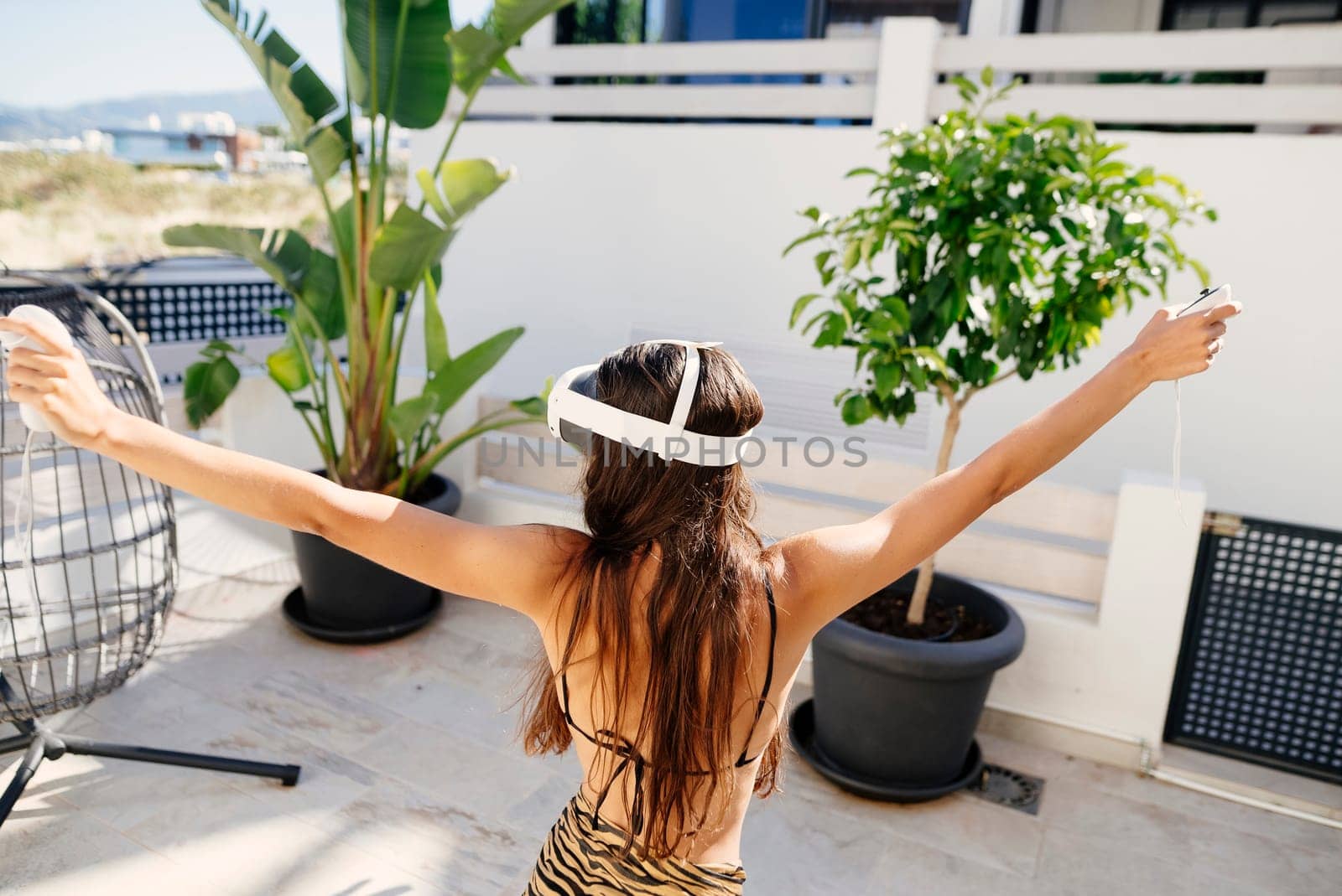 A person wearing a VR headset is relishing an immersive and thrilling experience while enjoying the outdoors