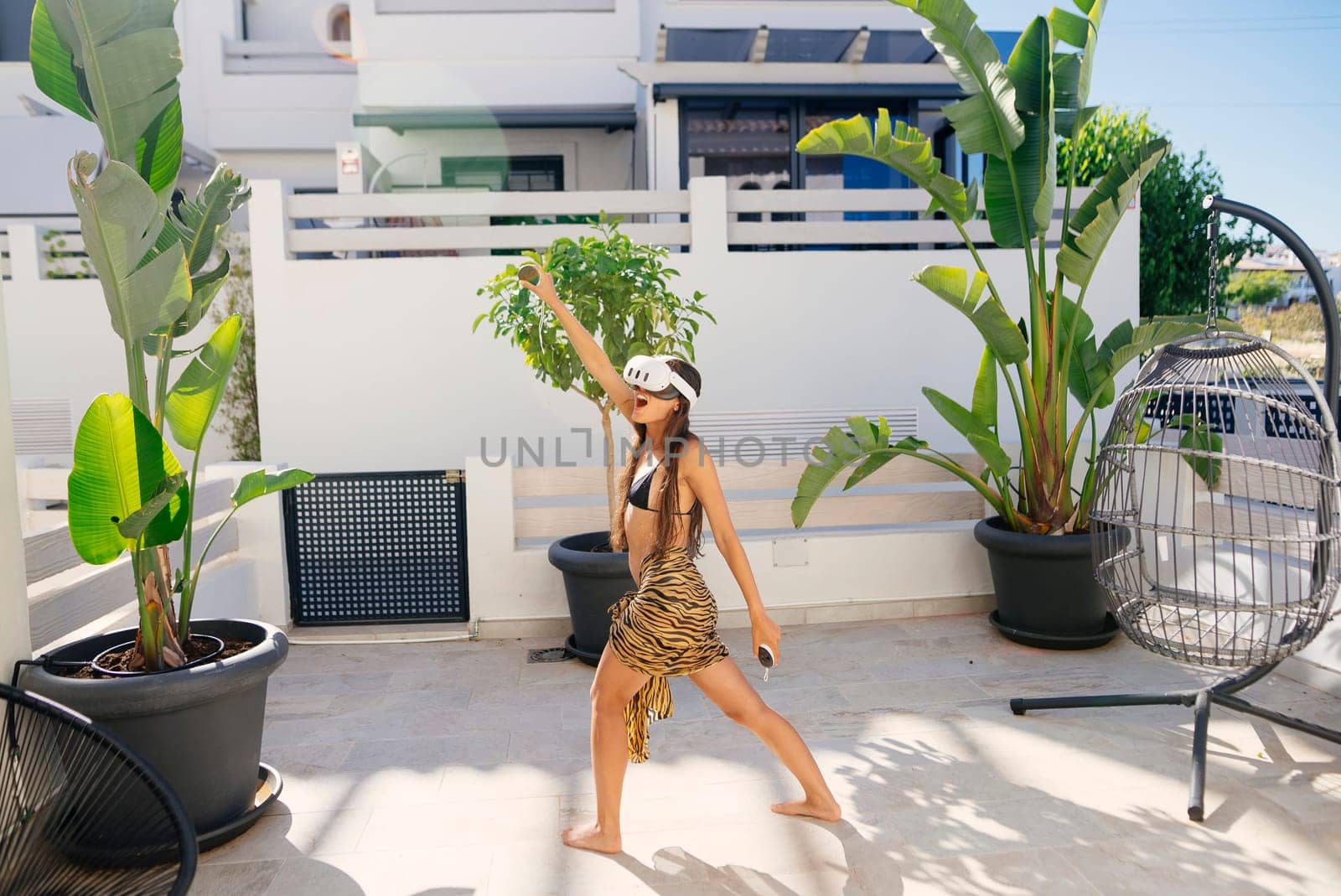 A vibrant and dynamic woman proudly showcasing her strength and grace in a beautifully sunlit tropical environment
