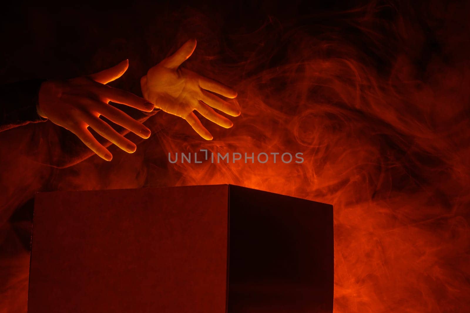 Man opens magic box with surprise on dark background, mystical box, surprise, halloween, monster box