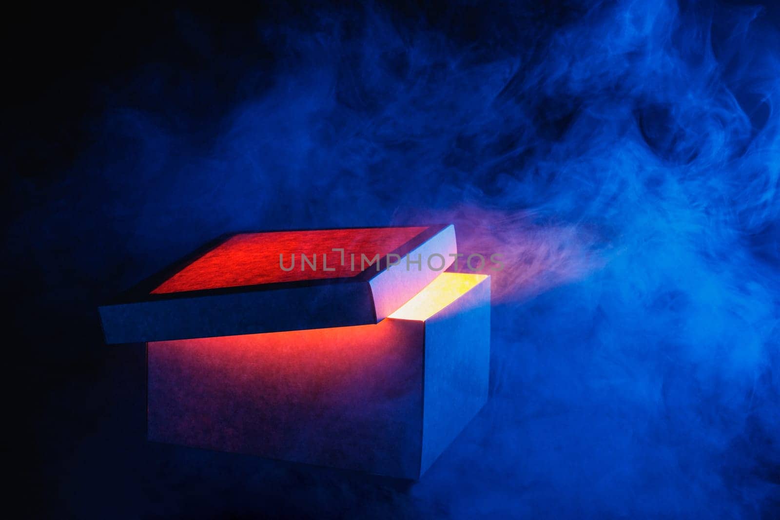 Man opens magic box with surprise on dark background, mystical box, surprise, halloween, monster box