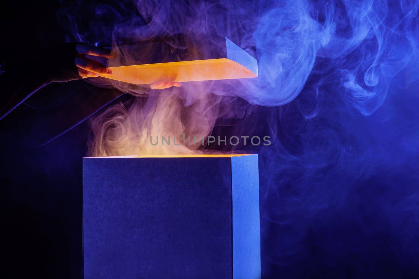 Man opens magic box with surprise on dark background, mystical box, surprise, halloween, monster box