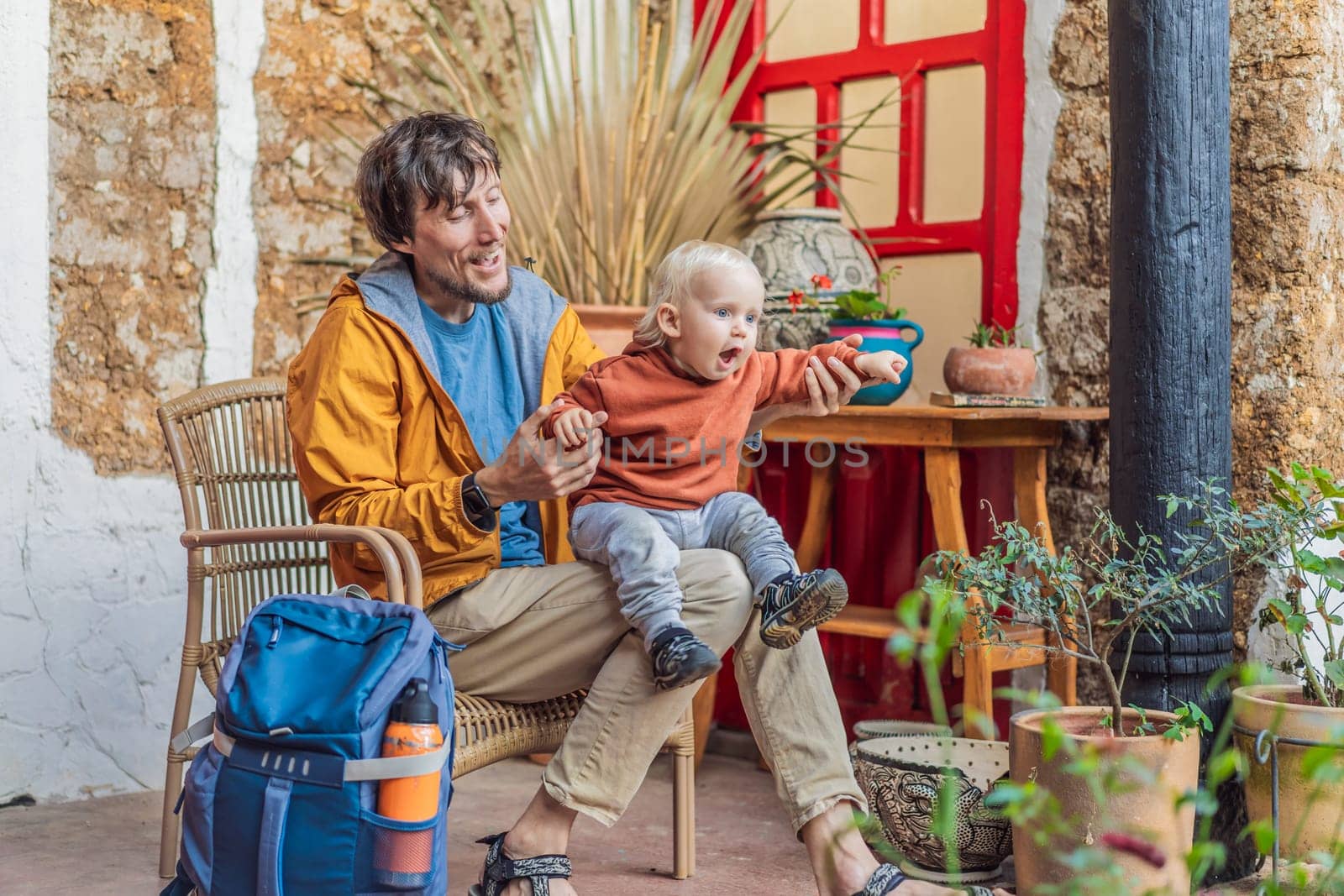 Father and his son tourists in a colonial house in San Cristobal de las Casas, Mexico. Cultural exploration, architecture, and travel experience concept.