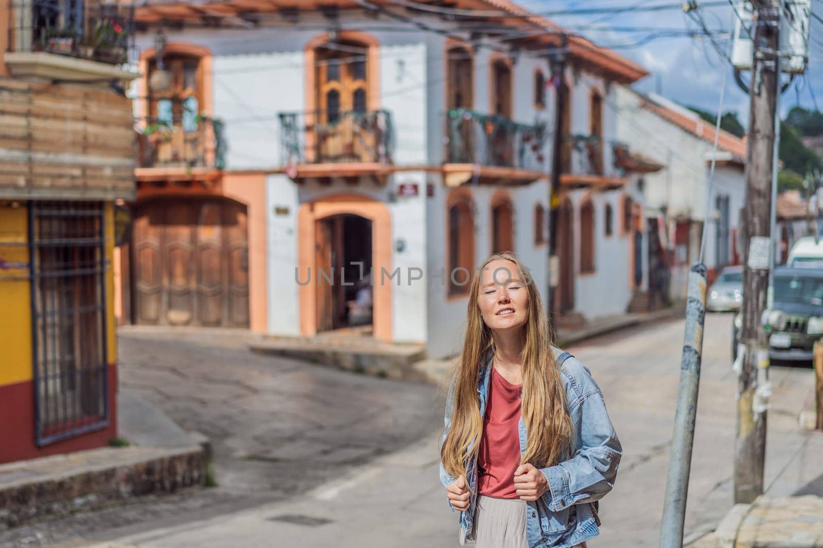 Female tourist walks through the colonial streets San Cristobal de las Casas, Mexico. Cultural exploration, architecture, and travel experience concept.