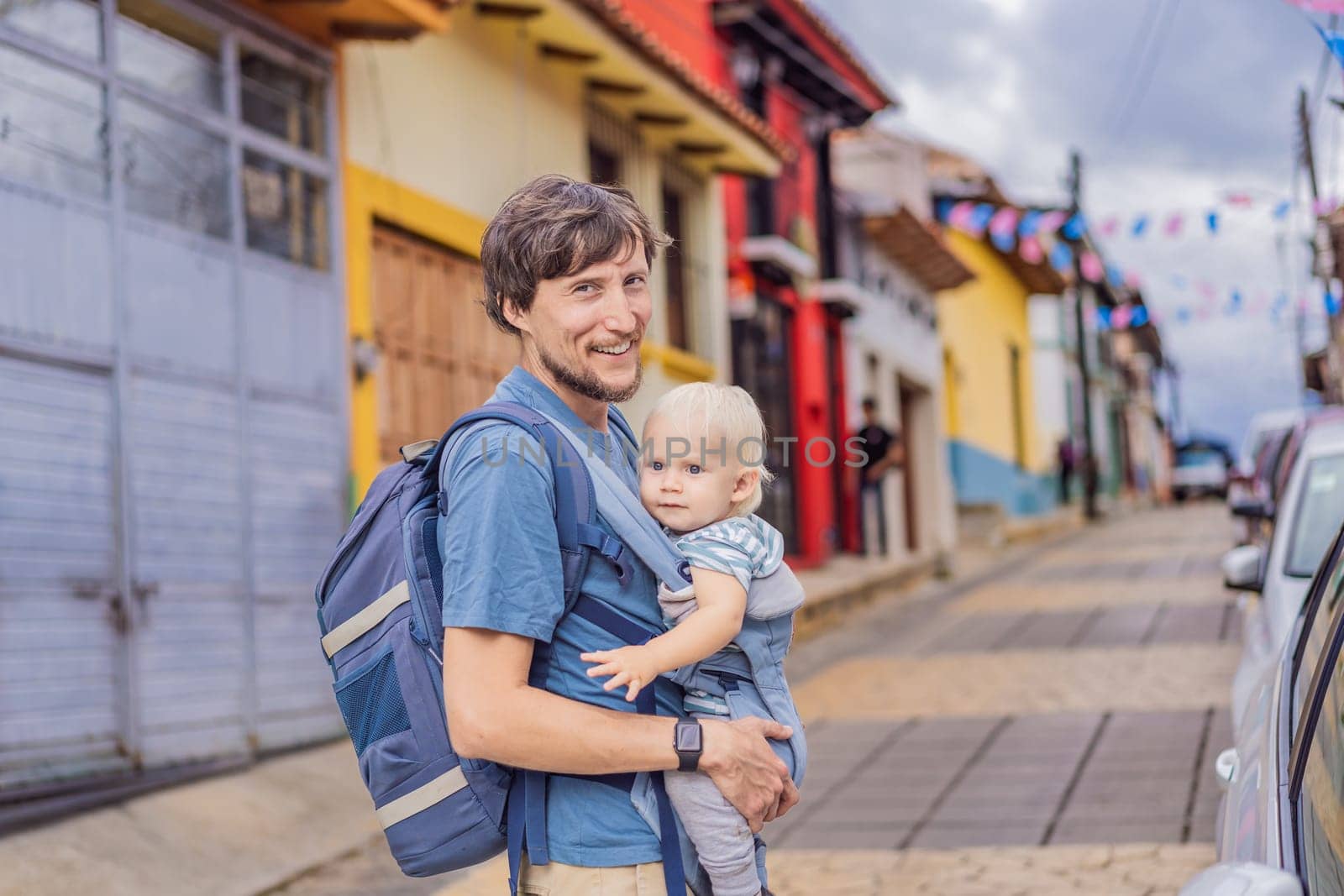 Father and his son tourists walks through the colonial streets San Cristobal de las Casas, Mexico. Cultural exploration, architecture, and travel experience concept.