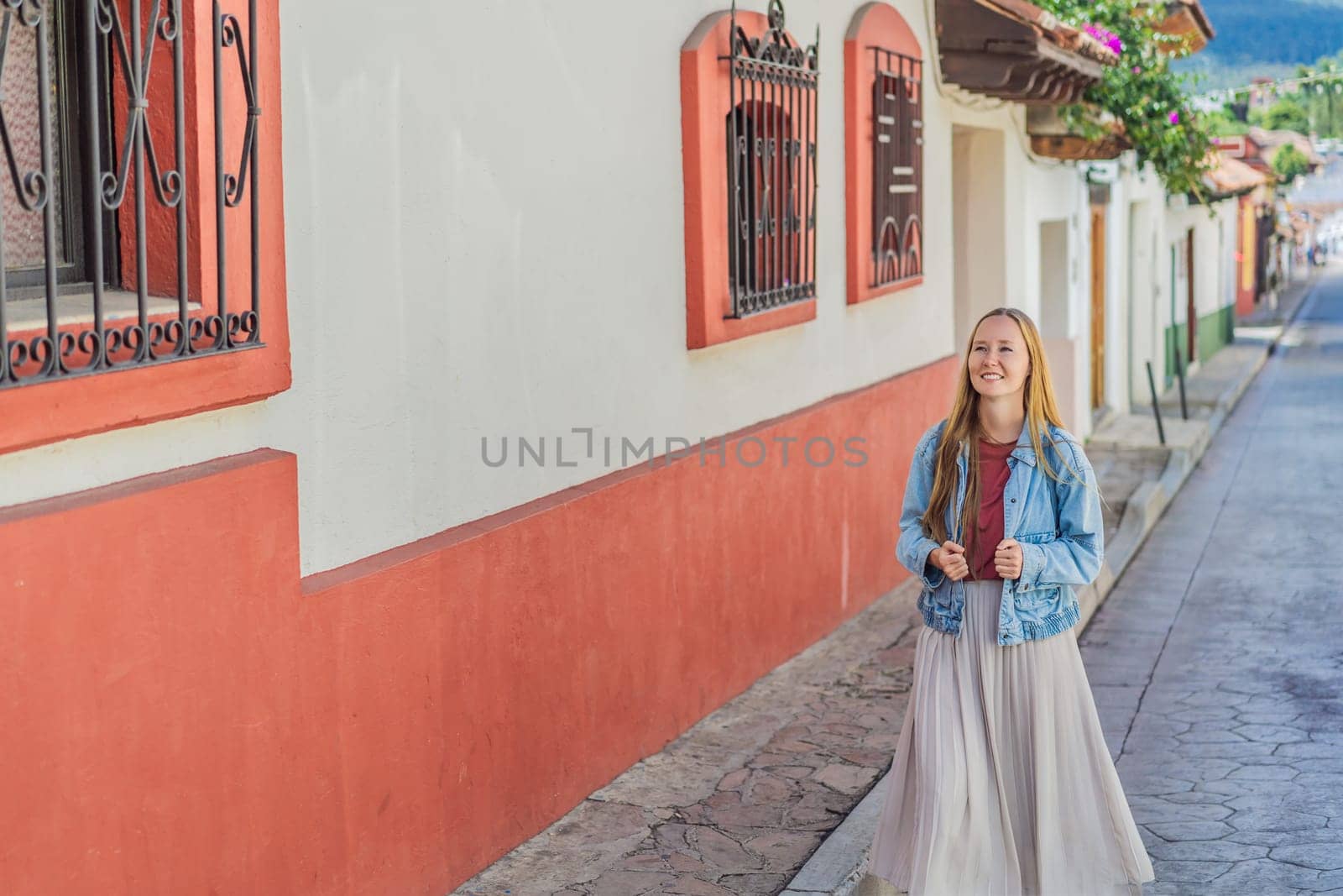 Female tourist walks through the colonial streets San Cristobal de las Casas, Mexico. Cultural exploration, architecture, and travel experience concept.