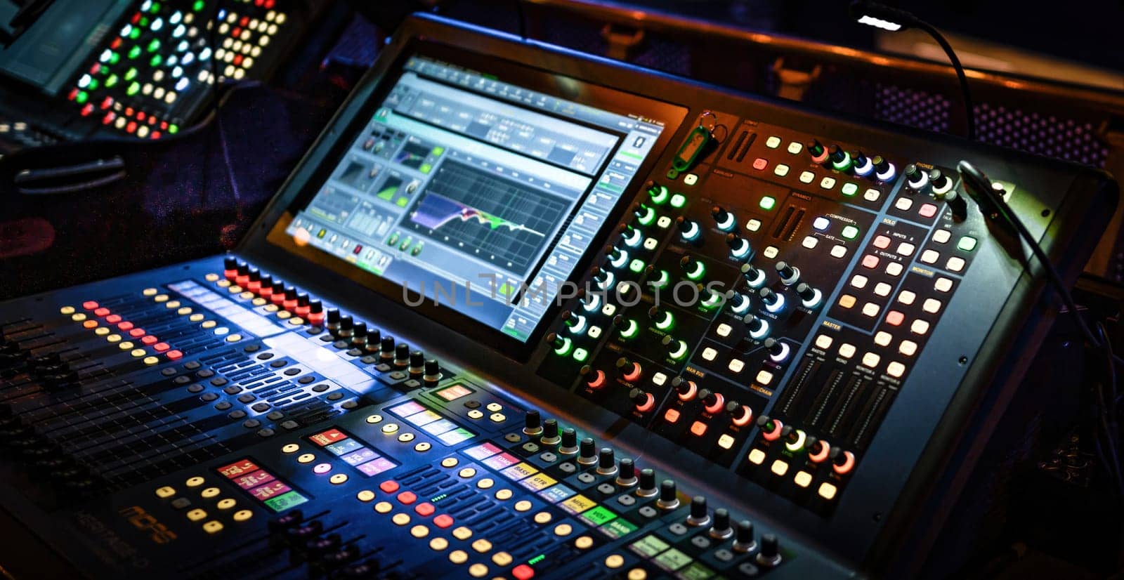 Professional sound and audio adjusting control panel with buttons, sliders and display. Digital music record mixer equipment