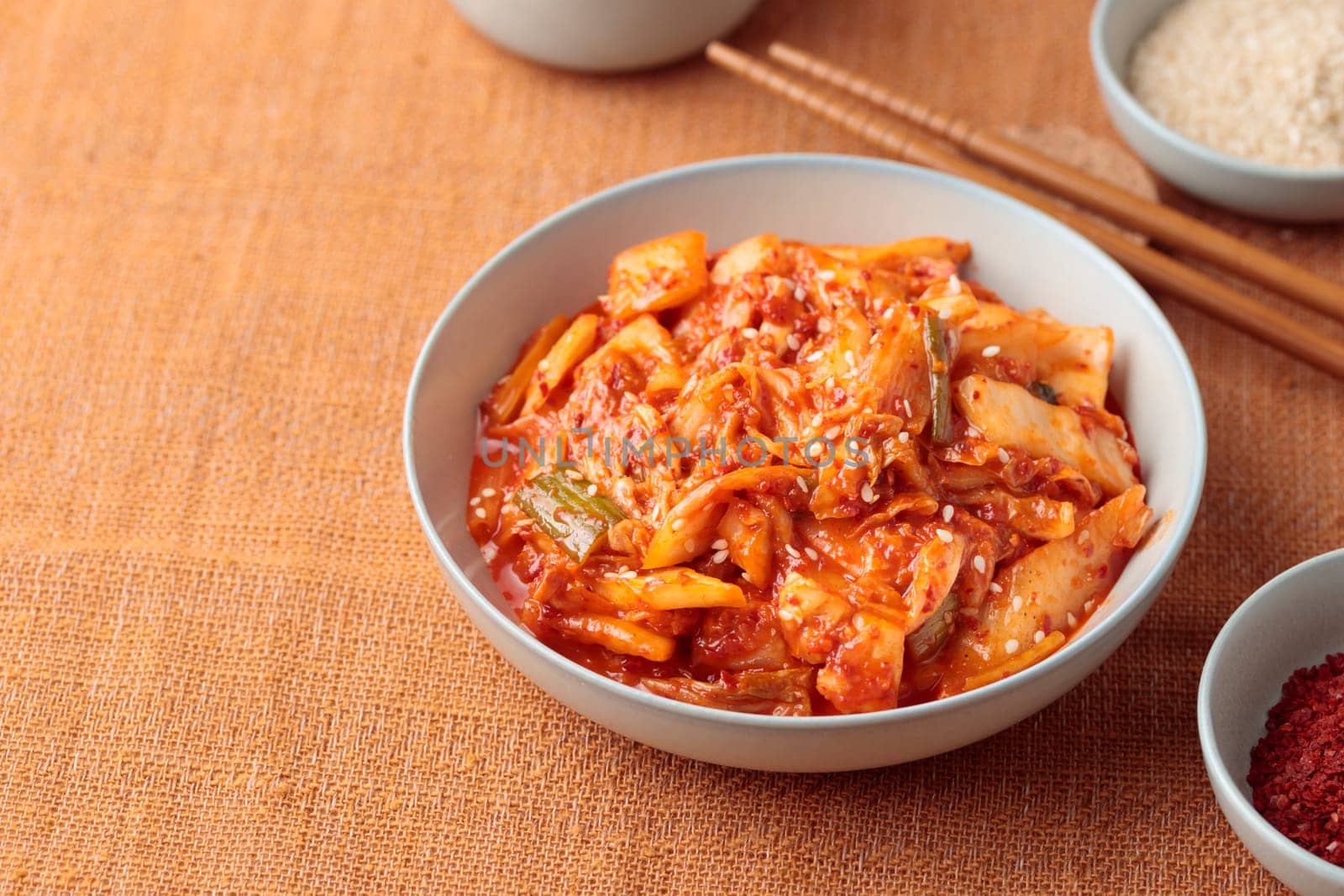 Kimchi, Kimchee in the Bowl, Red Spicy Kim Chi, Hot Fermented Napa Cabbage, Traditional Jimchi, Korean cuisine, top view horizontal banner with a copy space