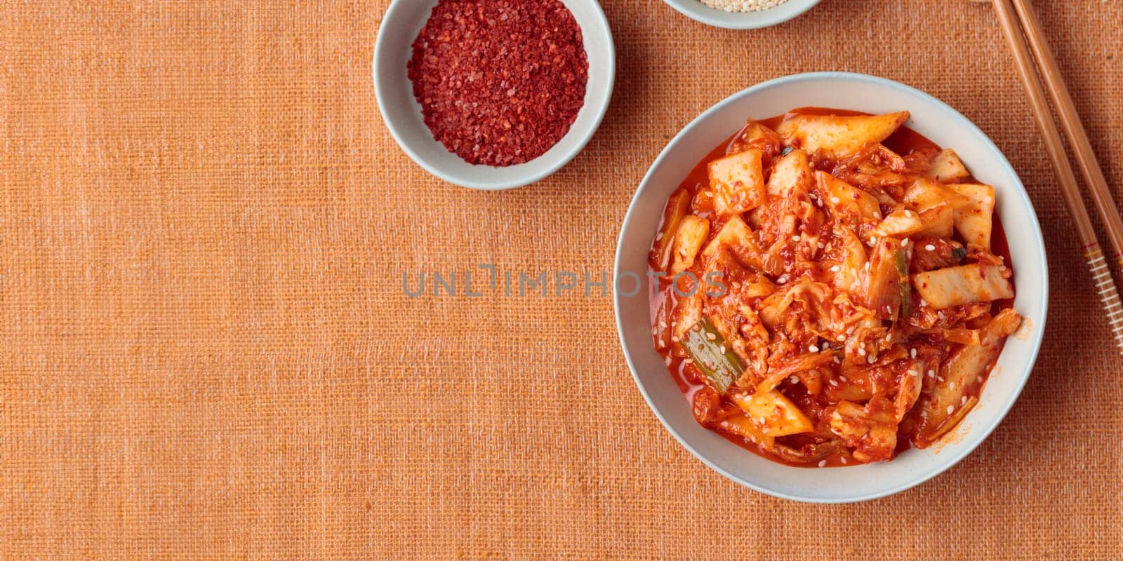 Kimchi, Kimchee in the Bowl, Red Spicy Kim Chi, Hot Fermented Napa Cabbage, Traditional Jimchi, Korean cuisine, top view horizontal banner with a copy space
