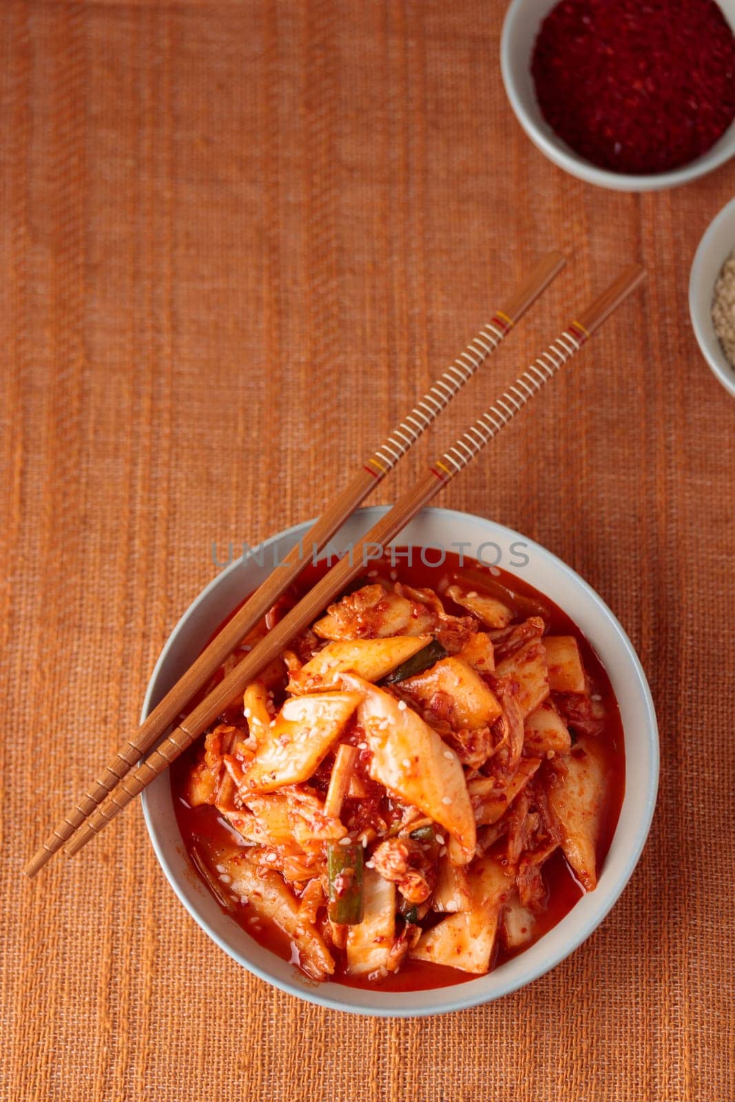 Kimchi, Kimchee in the Bowl, Red Spicy Kim Chi, Hot Fermented Napa Cabbage, Traditional Jimchi, Korean cuisine, top view banner with a copy space