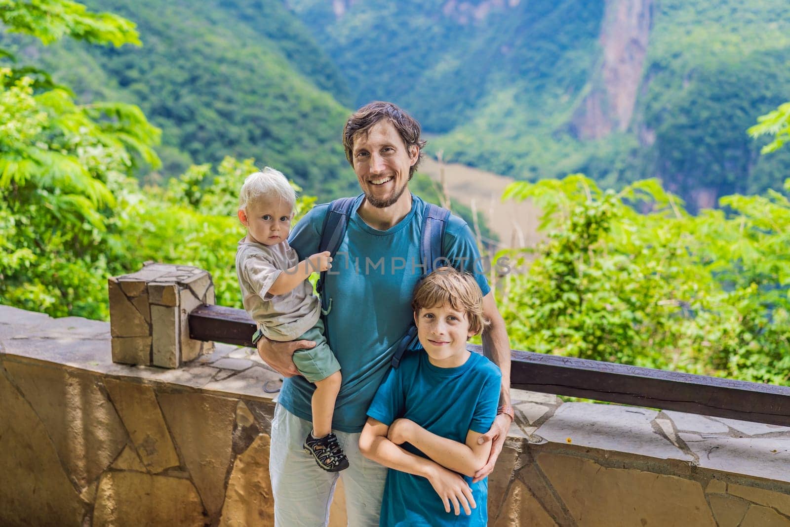Dad and his two sons baby and teenager travelers exploring Sumidero Canyon National Park, Mexico. Adventure, natural exploration, and travel experience concept.