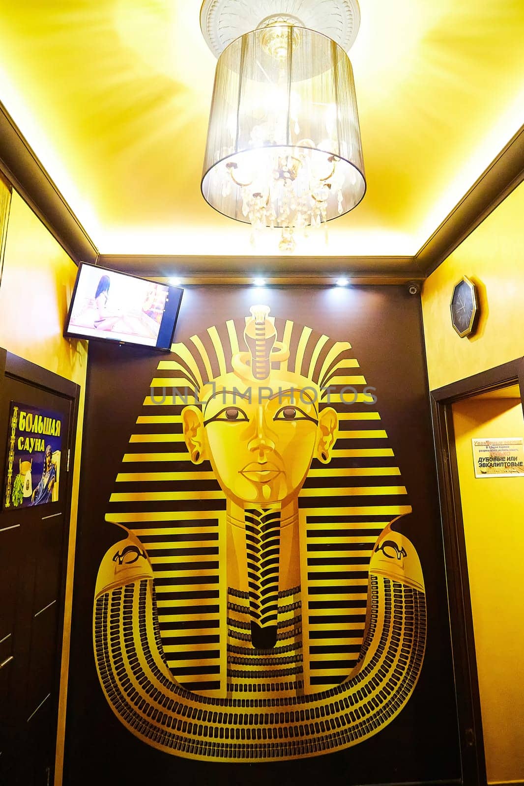 Kirov, Russia - November 10, 2021: This artwork showcases a pharaoh's visage surrounded by pyramids and hieroglyphics in a brightly lit room.