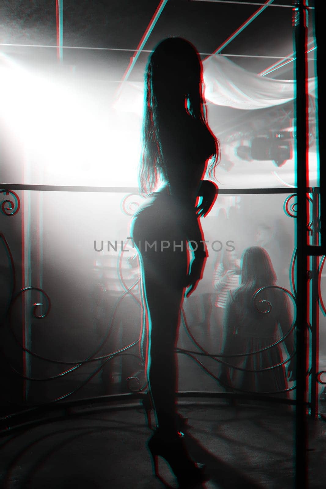 slender girl dancer posing at a nightclub with a sexy figure and body. Black and white photo with glitch effect and small grain