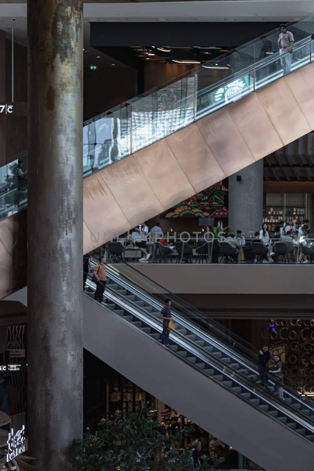 Bangkok, Thailand - 28 Sep, 2024 - The side view of the escalators for facilities inside ICONSIAM shopping mall, Structural interior design of escalator is shaped like the letter K. Dark tone, Space for text, Selective focus.
