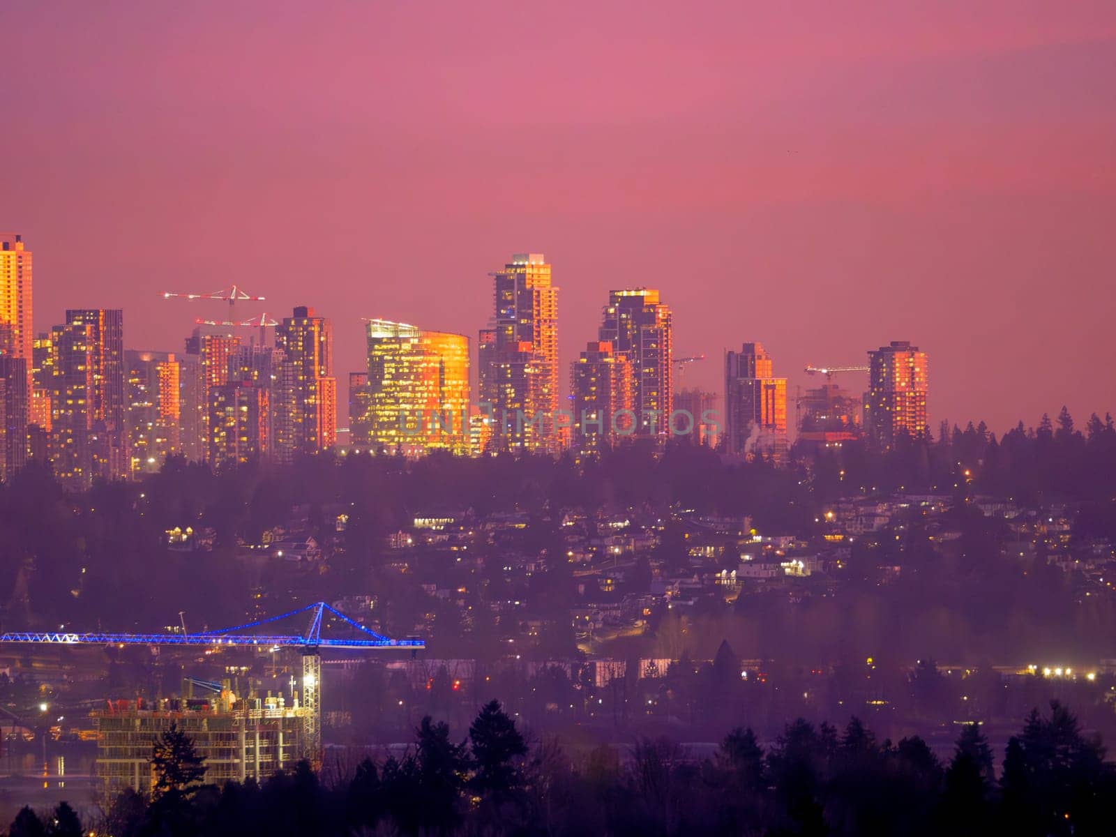 Unusual night city silouette highlighted with sunset rays in Surrey, BC.