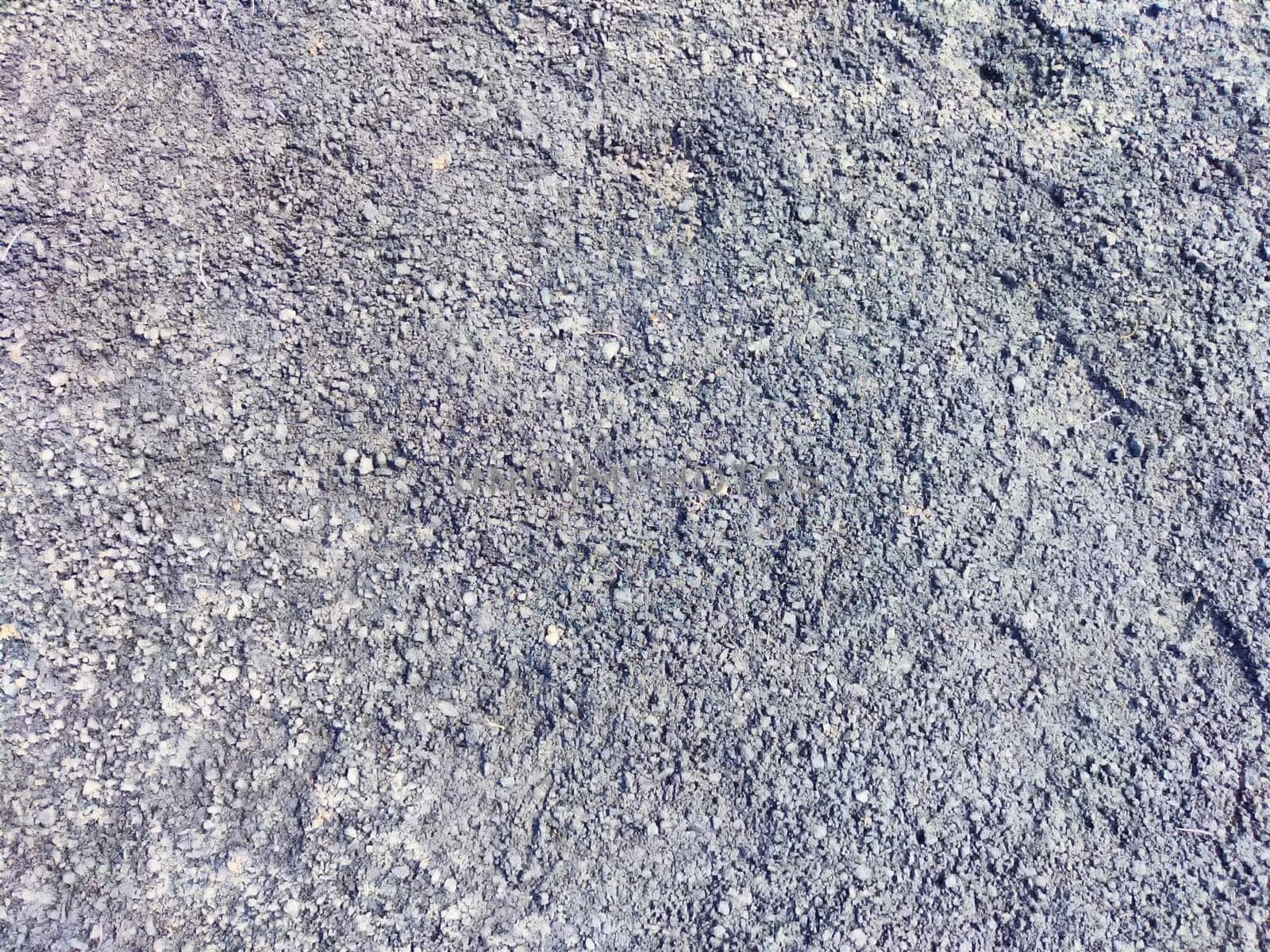 Gravel texture seen at a construction site under bright daylight.