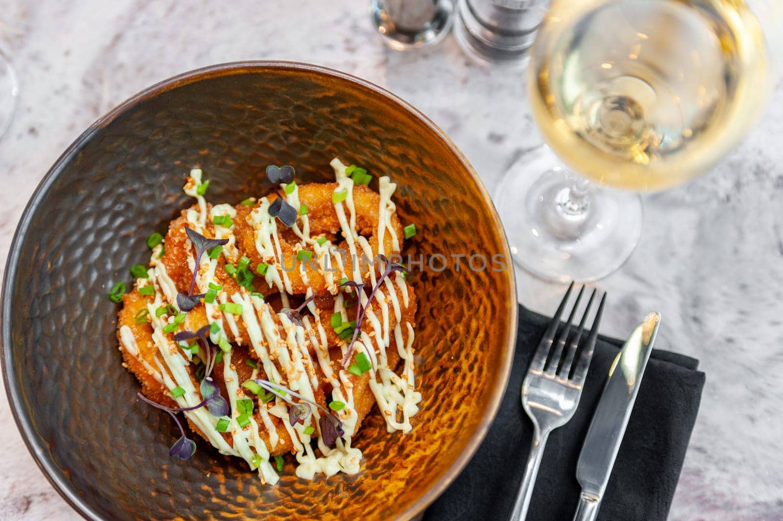 Breaded squid rings deep fried with a glass of white wine. High quality photo