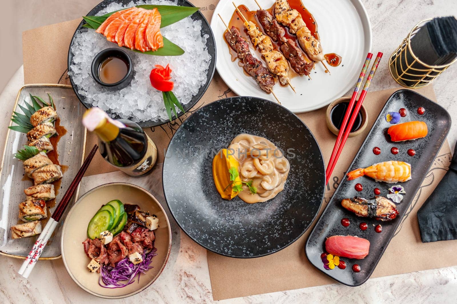 Set of Japanese dishes: sushi, nigiri, sashimi, yakitori and a sushi, nigiri, sashimi, yakitori on the table in a restaurant