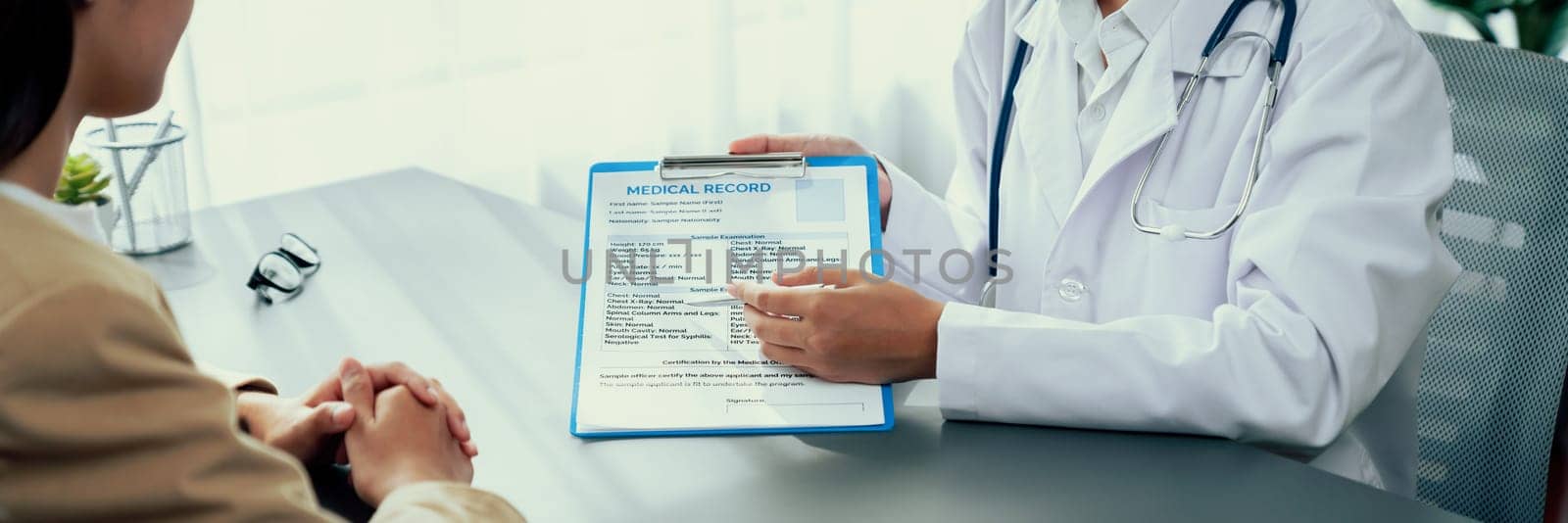 Doctor show medical diagnosis report to young couple. Neoteric by biancoblue