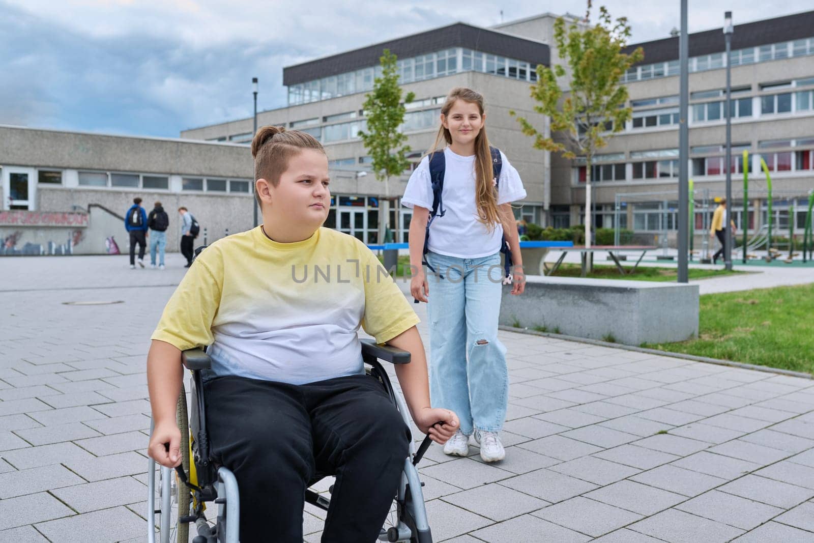 Children go to school, boy 11, 12 years old on a wheelchair close-up. Education, childhood, health, disability, inclusiveness concept