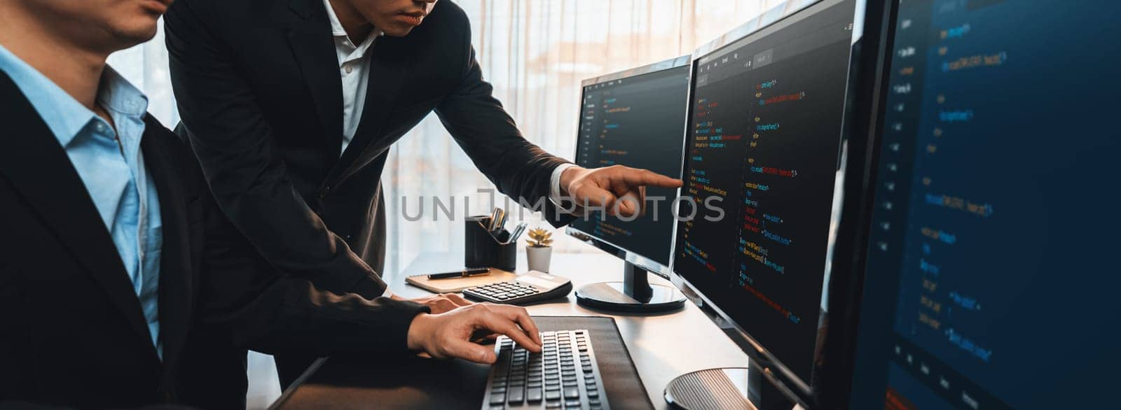 Software development team working together in office, coding script display on computer monitor. Programmer and software engineer working in tech developer company. Trailblazing