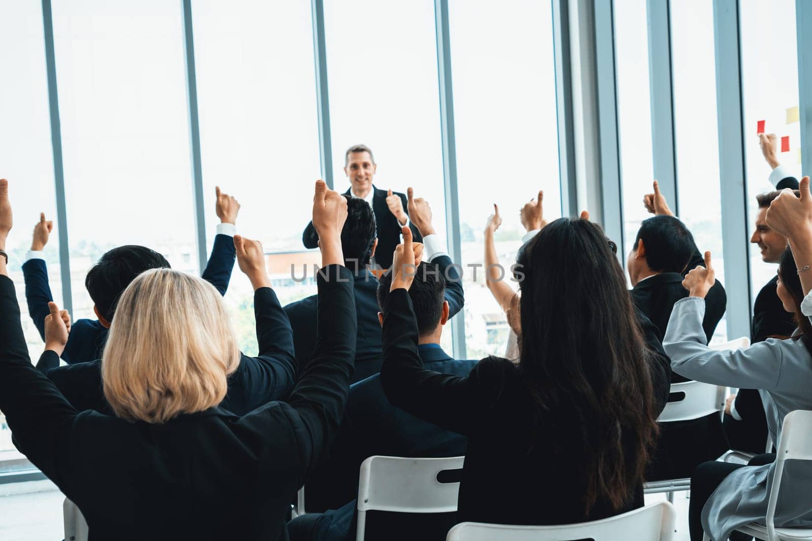 Group of business people meeting in a seminar conference . Audience listening to instructor in employee education training session . Office worker community summit forum with expert speaker . Jivy