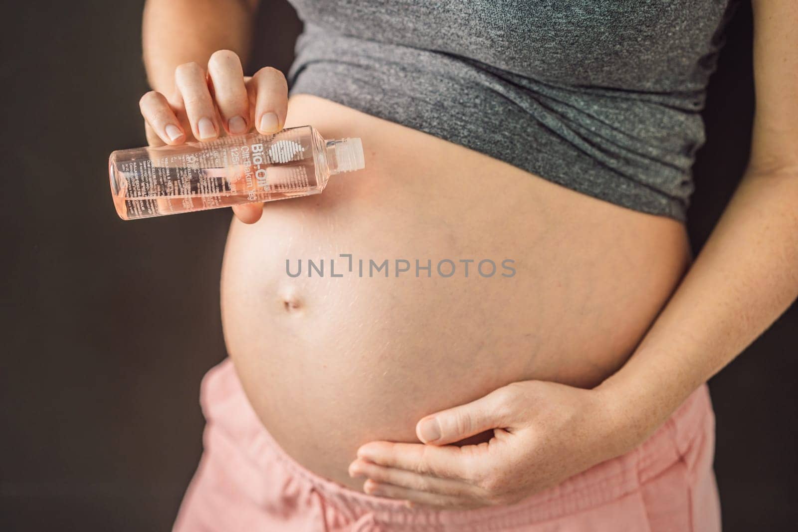 Turkiye, Antalya 02.02.2022: Woman holds Bio Oil, a nurturing choice for pregnant women. A soothing image of care and wellness during pregnancy.