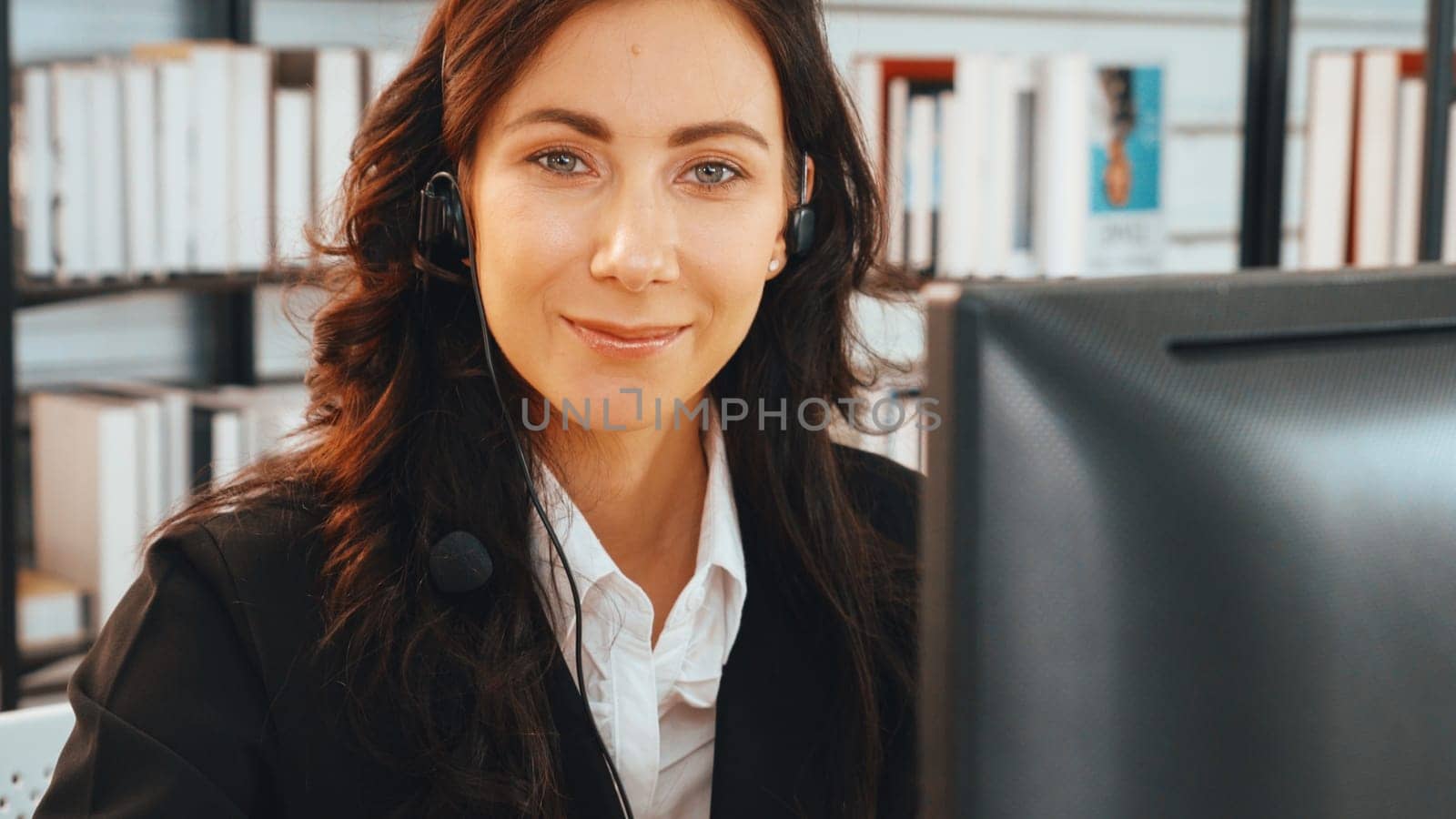 Business people wearing headset working in office to support remote customer or colleague. Call center, telemarketing, customer support agent provide service on telephone video conference call. Jivy