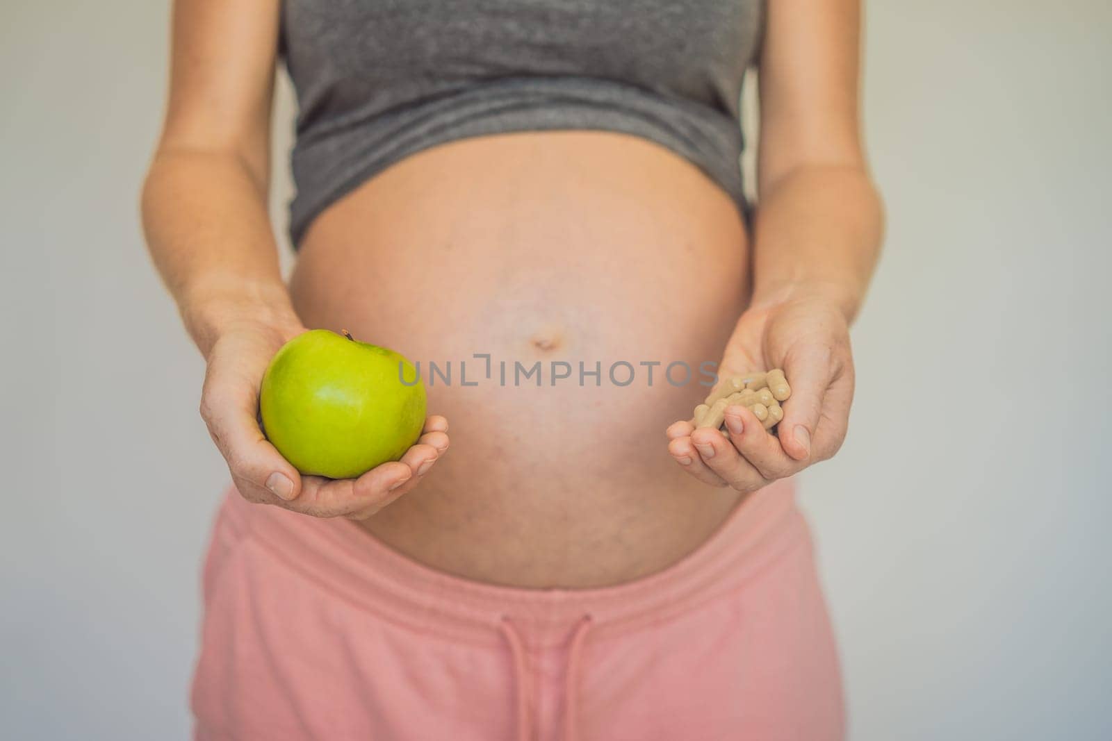 A thoughtful moment: A pregnant woman contemplates choosing between natural fruit or supplements for their nutritional needs, a choice between nature and science.