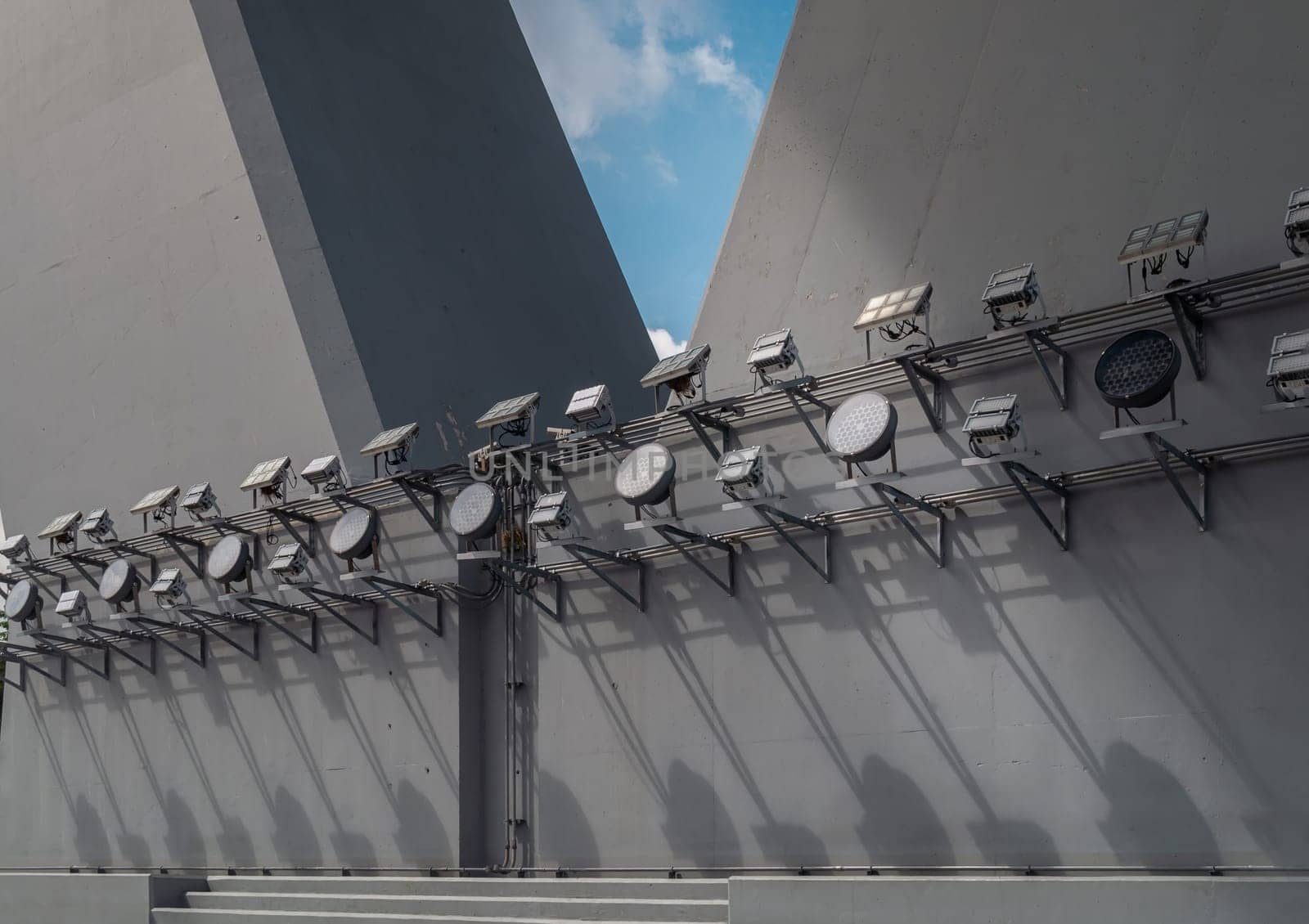 Bangkok, Thailand - 28 Sep, 2024 - Large outdoor LED flood lights spotlights shine for the bridge at night illuminated on Bridge foundation post. Outdoor spotlight for lighting the bridge on foundation pillar abutment of under the Bridge, Space for text, Selective focus.