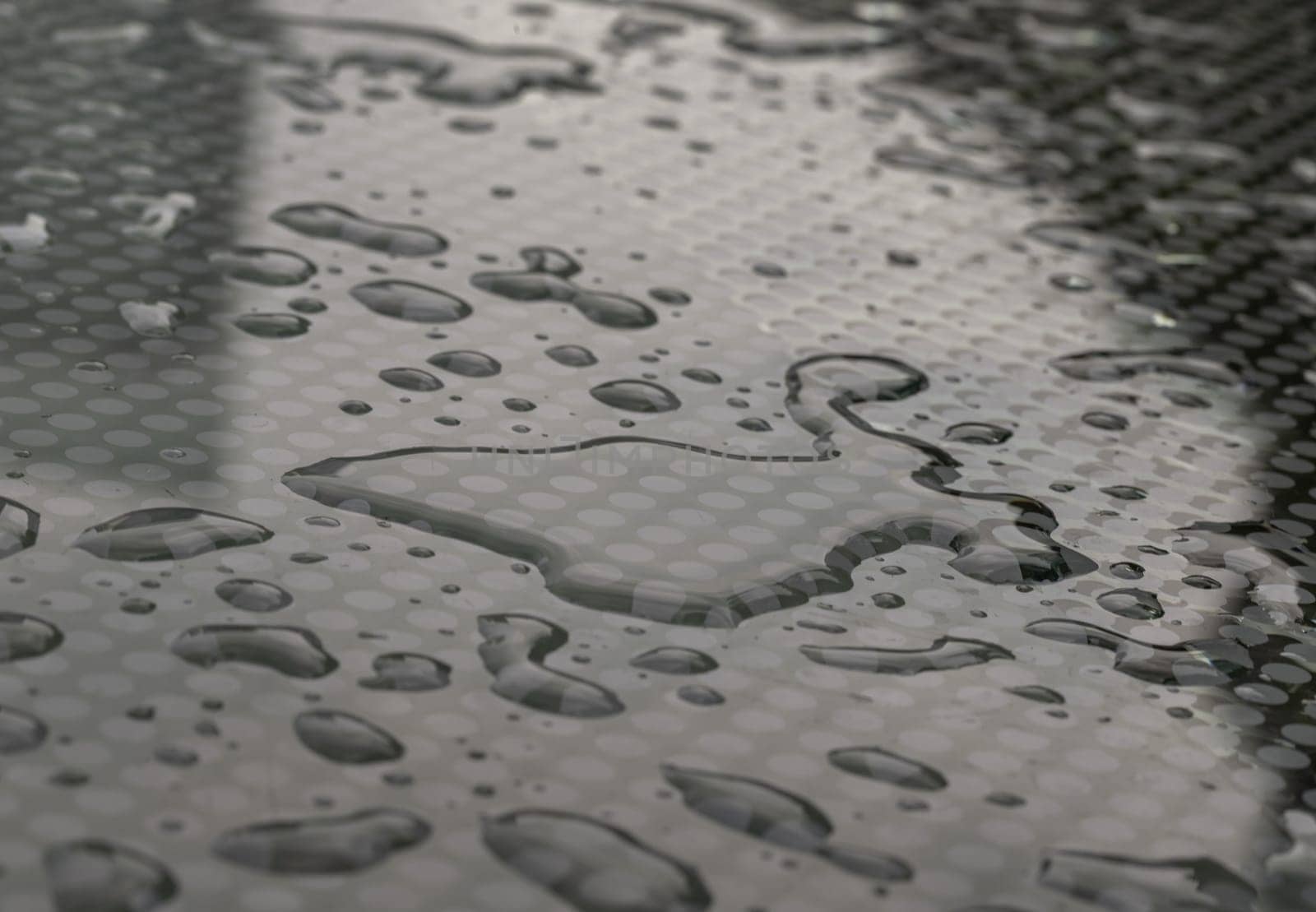 Natural Pattern of dew drops or raindrops on galss background. Detail of Water droplets caused by rain perched on surface of the Glass. Rain water drops on a Glass floor for wallpaper, Poster and Space for text, Selective focus.