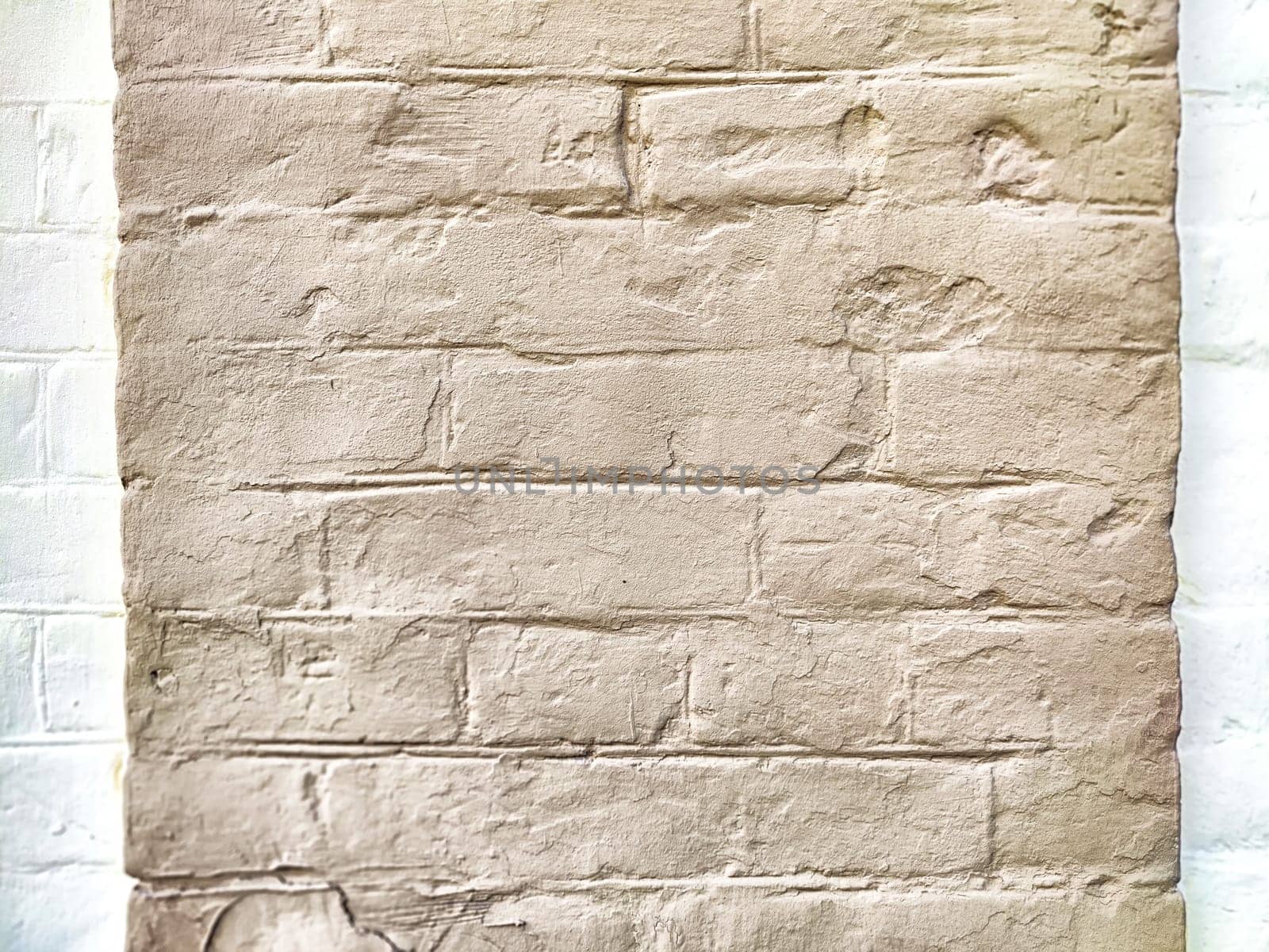 A light-toned wall displays a textured surface with slight shadows.