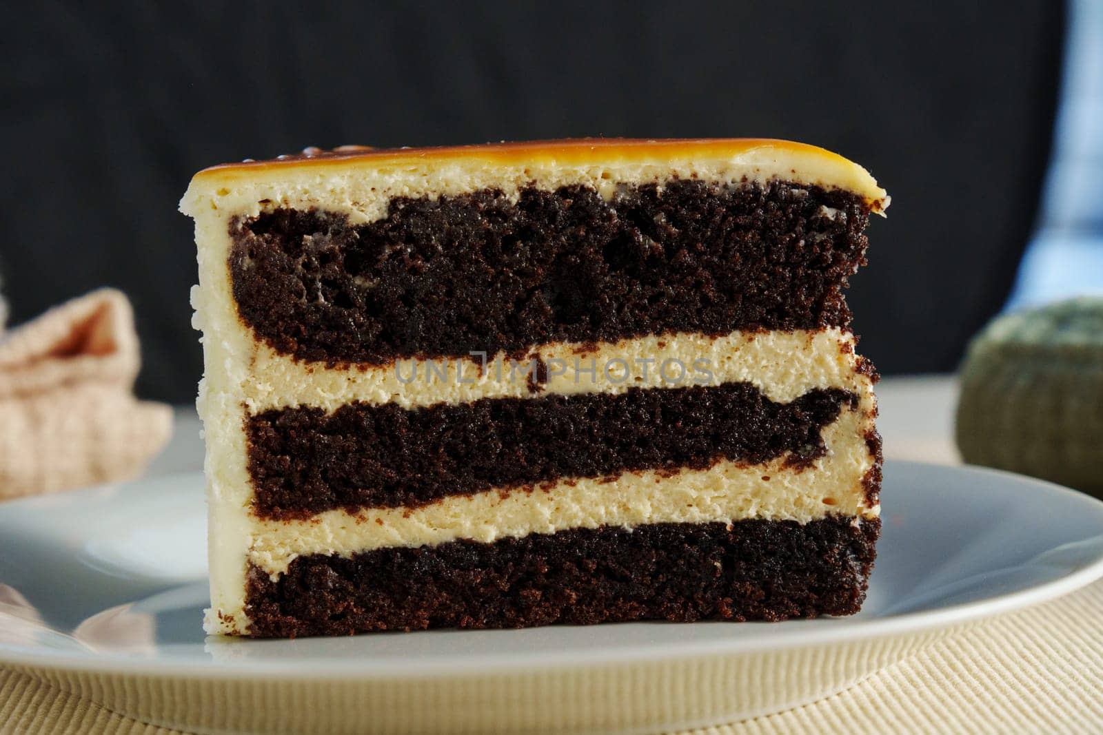 Layers of rich chocolate cake interspersed with velvety cream frosting create a tantalizing dessert experience, perfect for any celebration or indulgence.