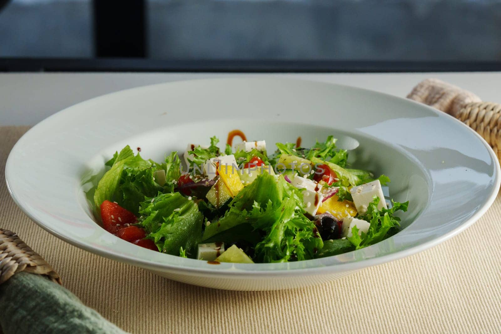 colorful plate filled with crisp lettuce, juicy cherry tomatoes, crunchy cucumbers, and creamy feta, harmoniously drizzled with balsamic dressing