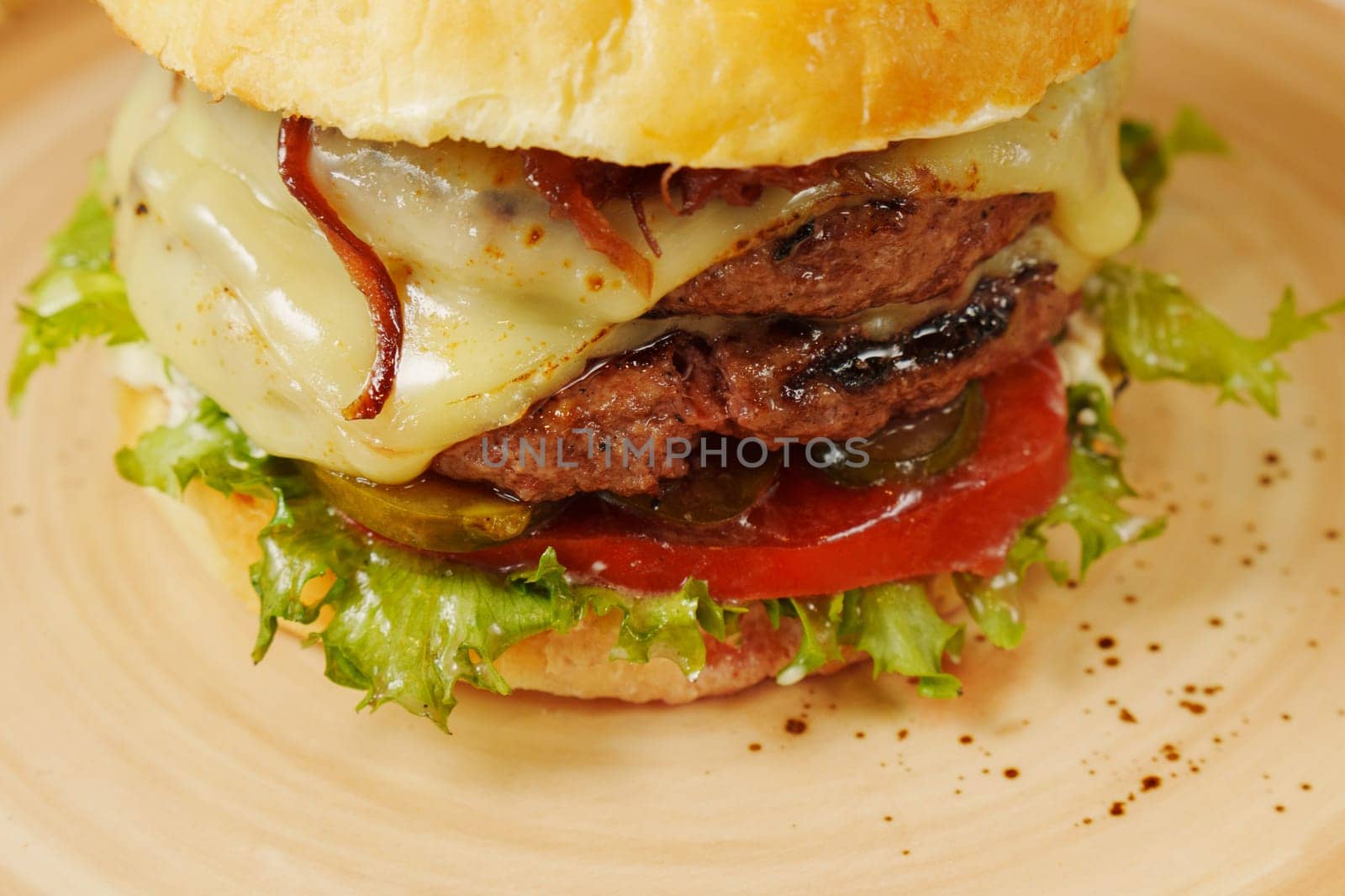 A mouthwatering burger is layered with fresh lettuce, ripe tomatoes, and melted cheese