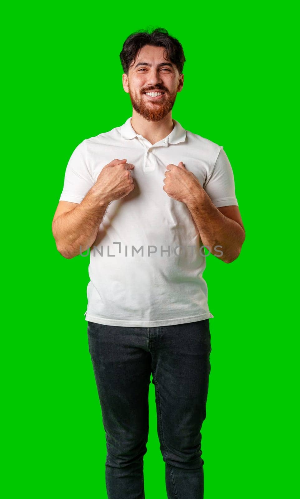 Smiling man in a white polo shirt standing confidently against a bright green background close up