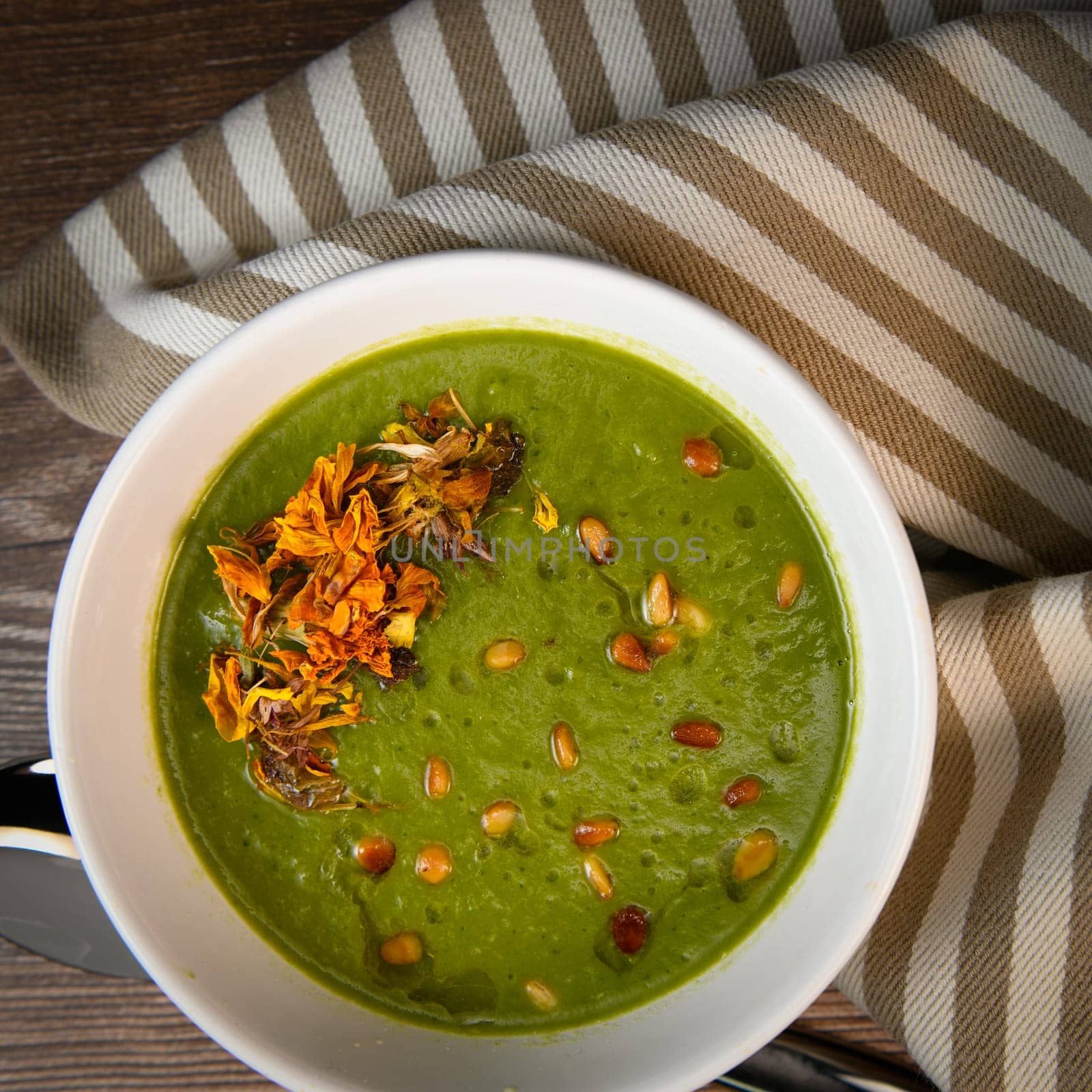 RECIPE FOR LEEK AND POTATO SOUP WITH GOLDEN PINE NUTS AND DRIED FLOWERS, High quality photo