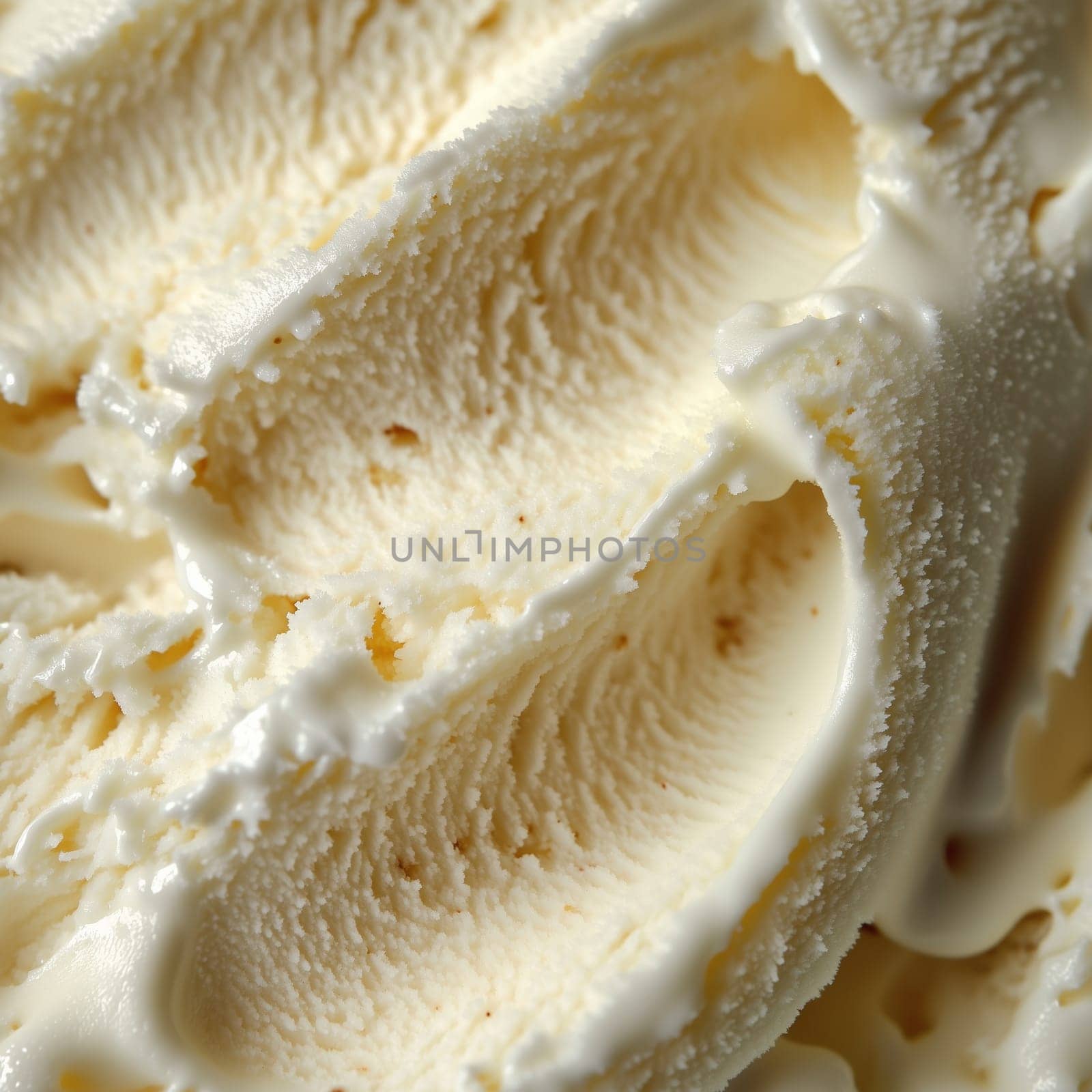 The rich, creamy texture of vanilla ice cream is highlighted in this close-up, showcasing its swirls and smoothness, perfect for summertime enjoyment.
